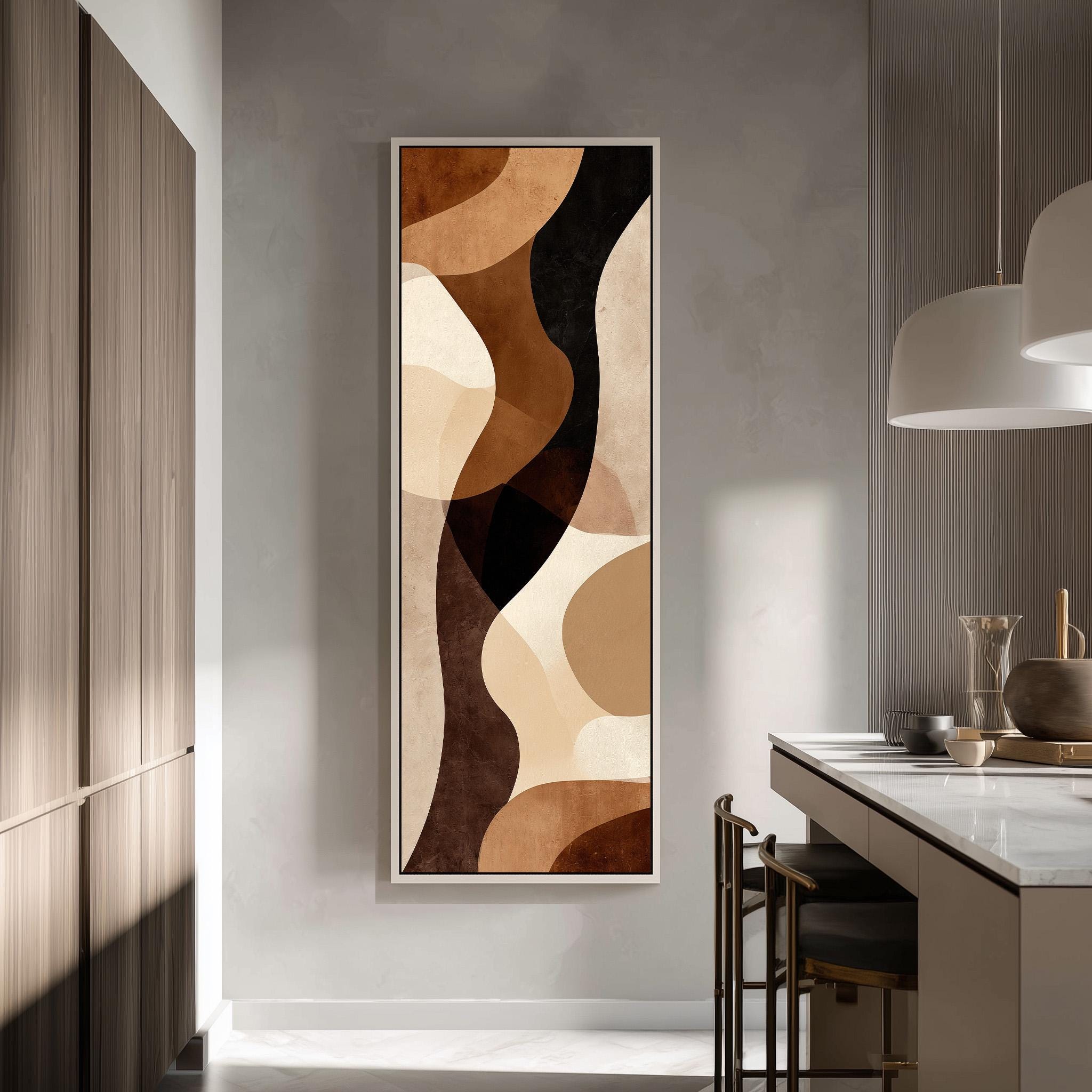 a modern kitchen with a large abstract painting hanging on the wall. The painting has a warm color palette of brown, beige, and orange, creating a cozy and inviting atmosphere. The kitchen is equipped with a white countertop and a sink, and there are chairs and a dining table visible in the space.