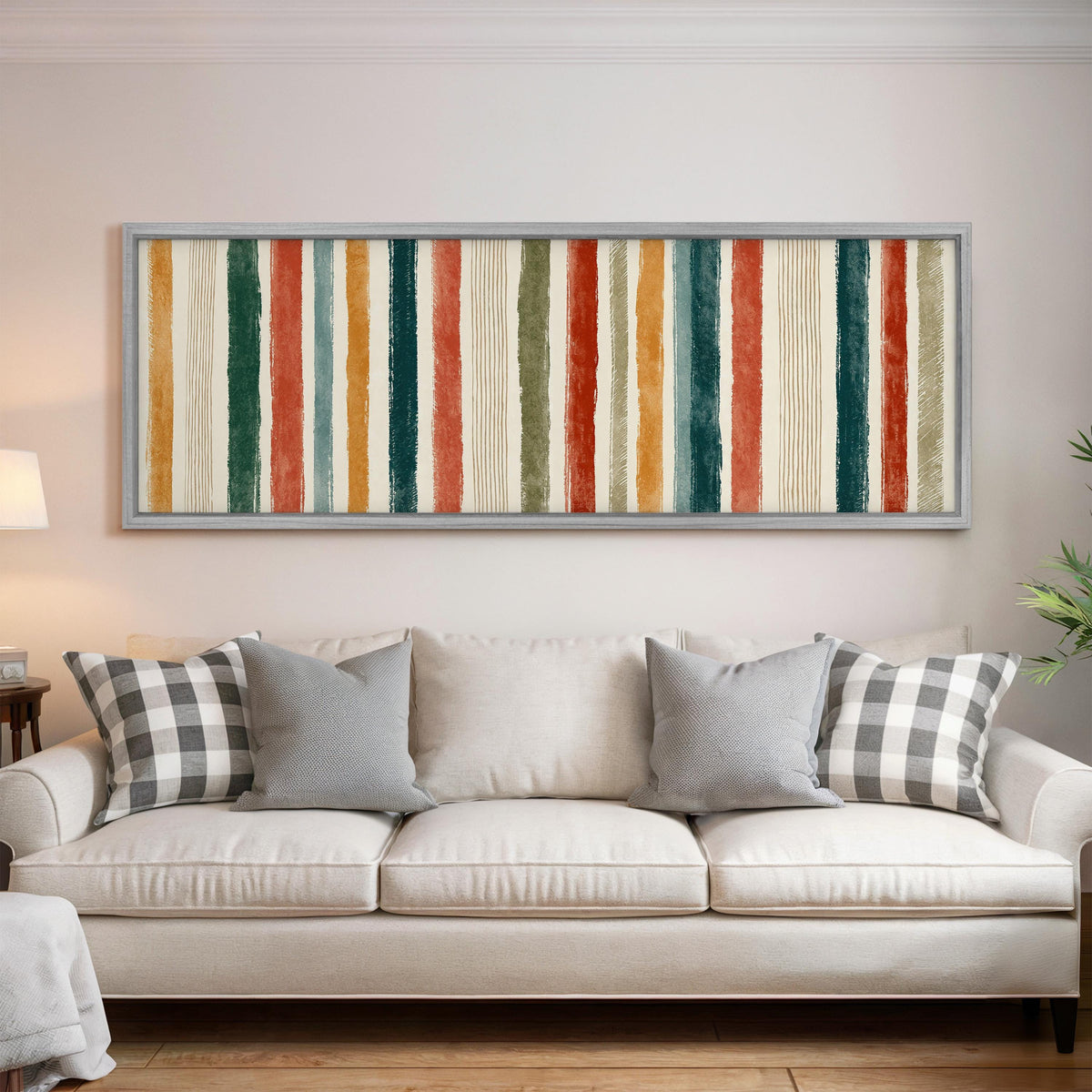 Boho watercolor stripes in mustard, teal and rust panoramic canvas print above a white sofa in a bright living room