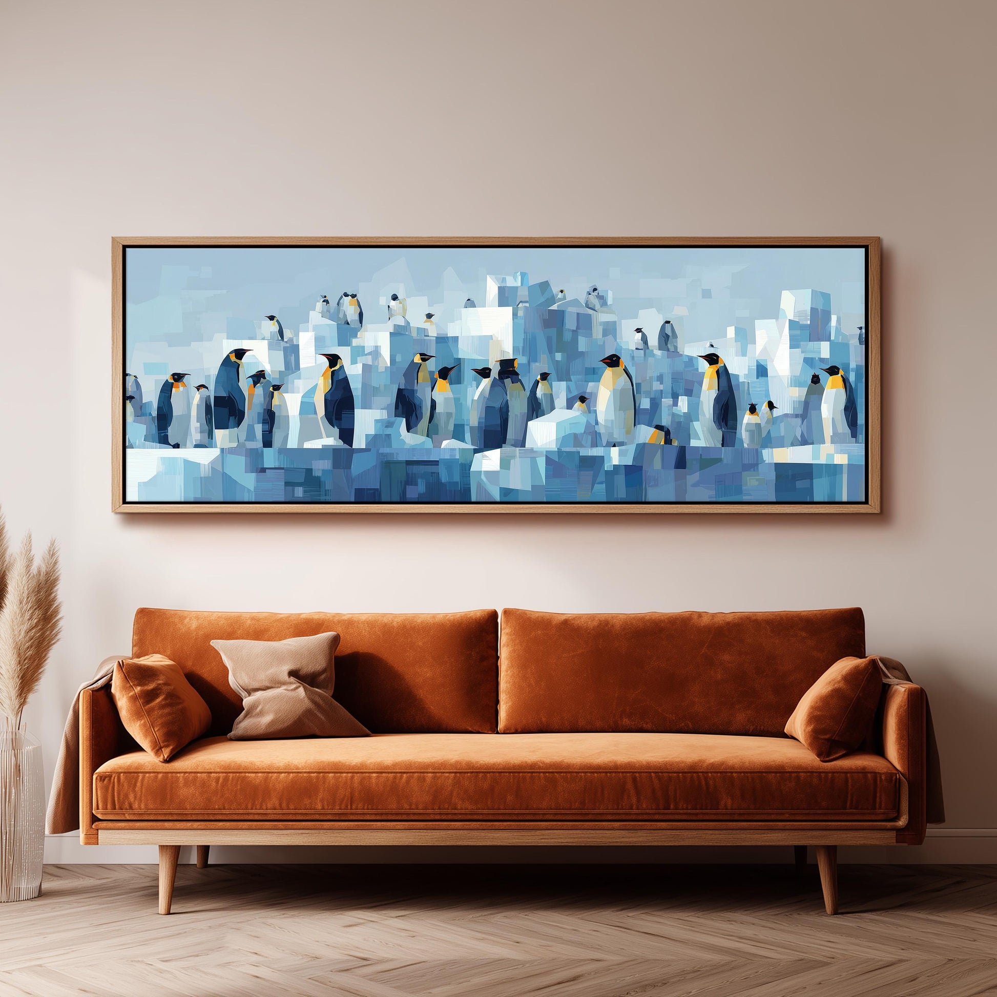 a large, abstract painting of penguins in a blue and white color scheme, hanging on a wall above a brown sofa.