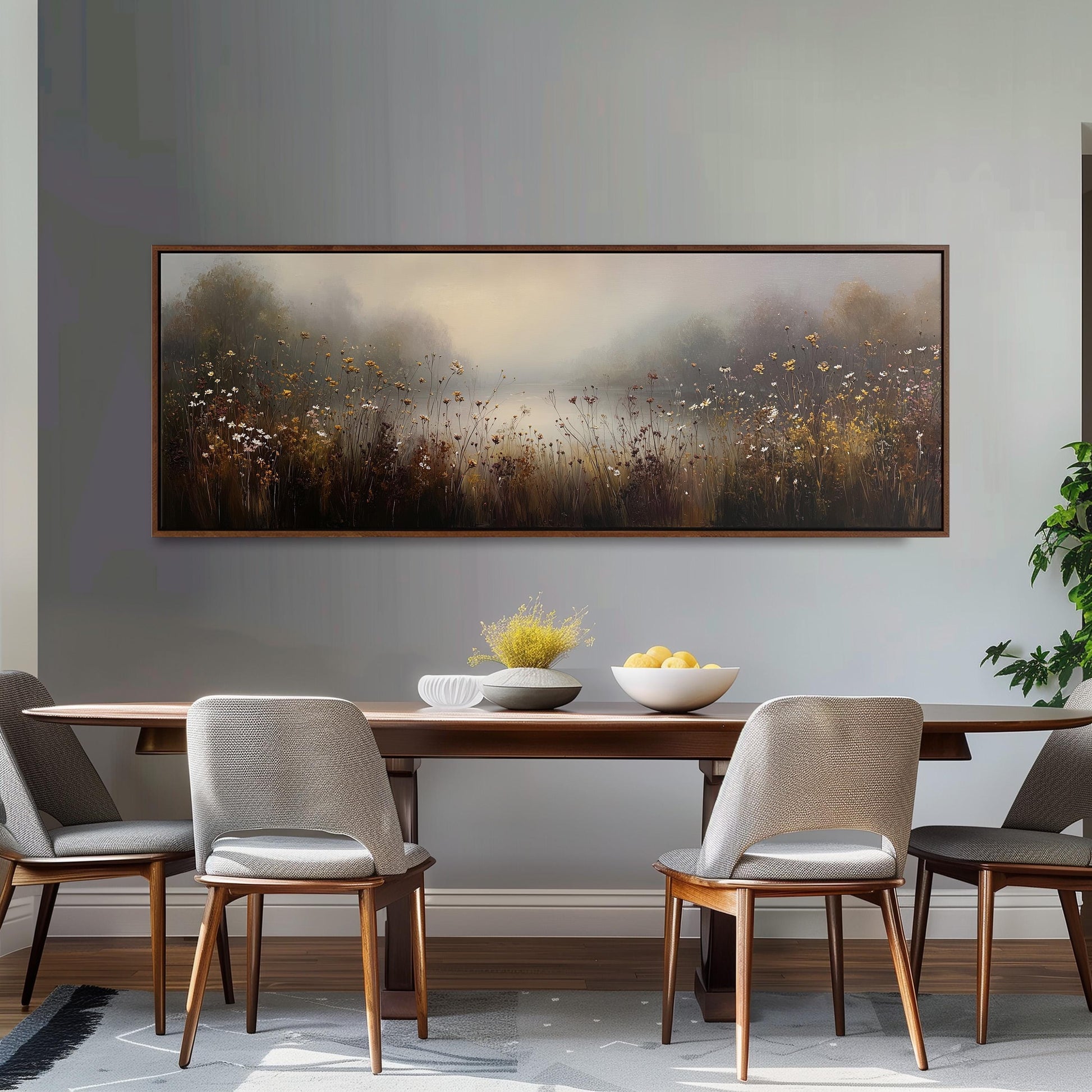 a dining room with a large painting of a field of flowers hanging on the wall above a wooden dining table with four chairs. The table is set with a bowl of fruit and a vase of flowers, creating a cozy and inviting atmosphere.