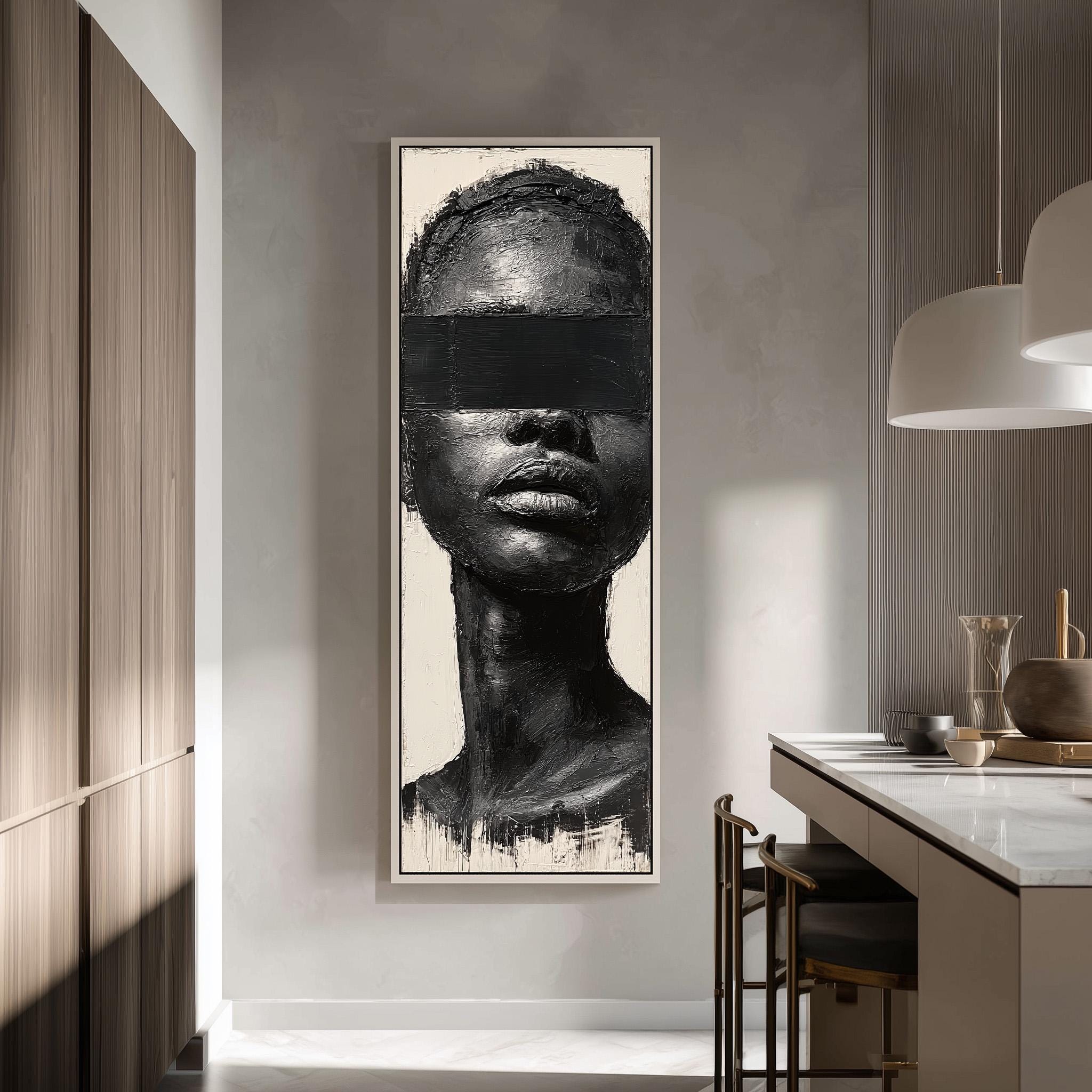 a large black and white portrait of a woman's face, hanging on a wall in a modern, minimalist interior space.
