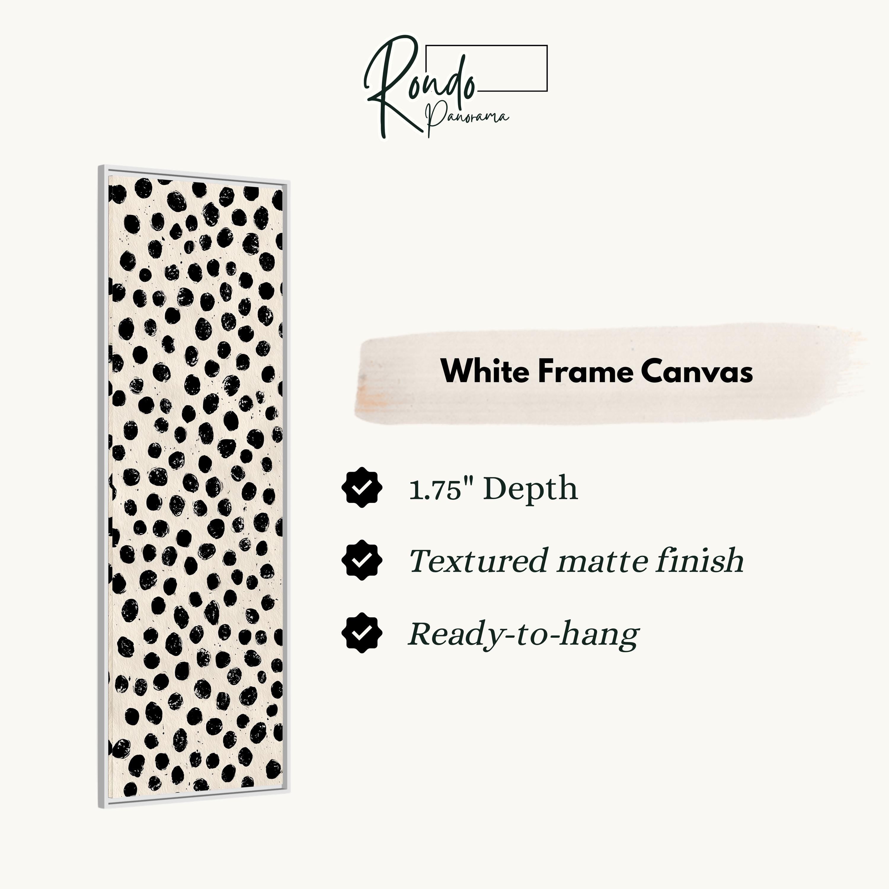 a white frame canvas with a black and white polka dot pattern.