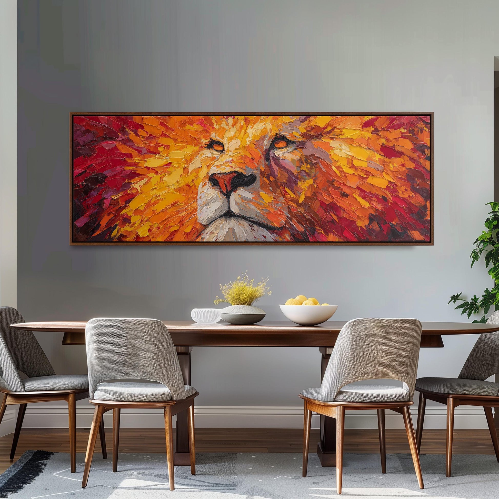 a large, colorful painting of a lion's face hanging on a wall above a wooden dining table with four chairs.