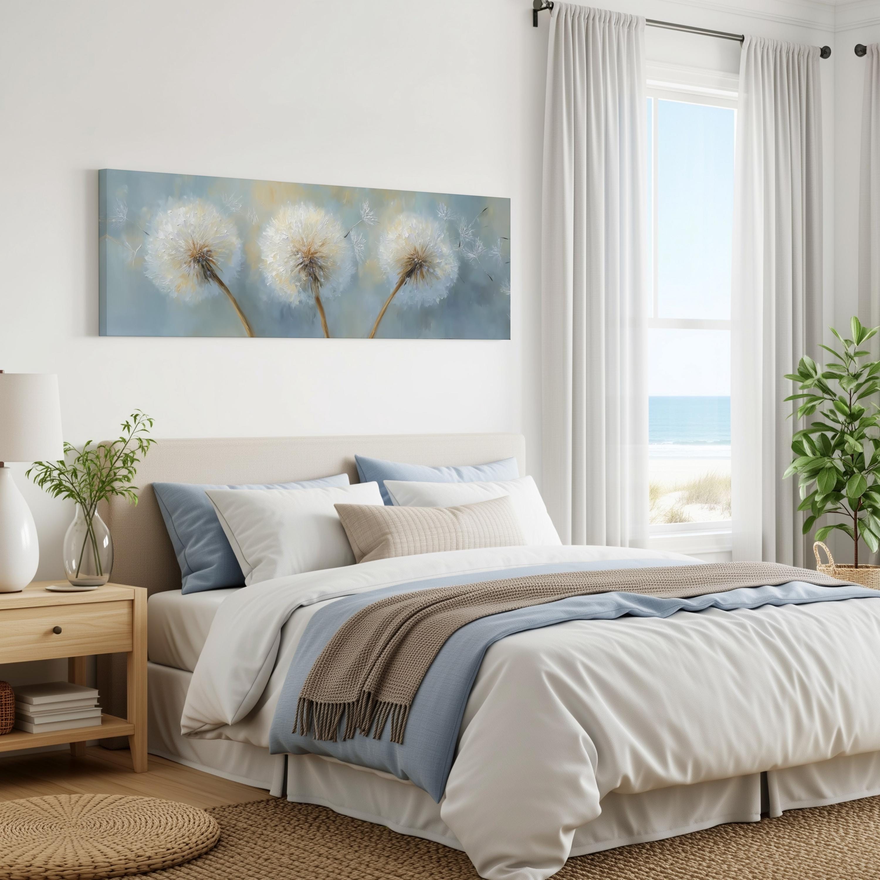 a serene bedroom with a large bed, a painting of dandelions on the wall, and a window overlooking the ocean.