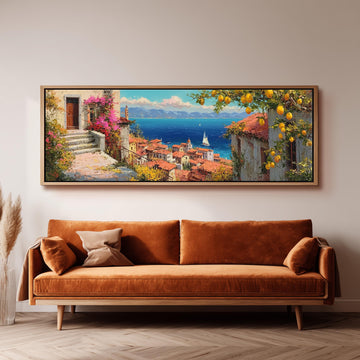 a large, framed painting of a picturesque coastal town with a harbor, featuring a ship and a lighthouse, hanging on a wall above a brown sofa.