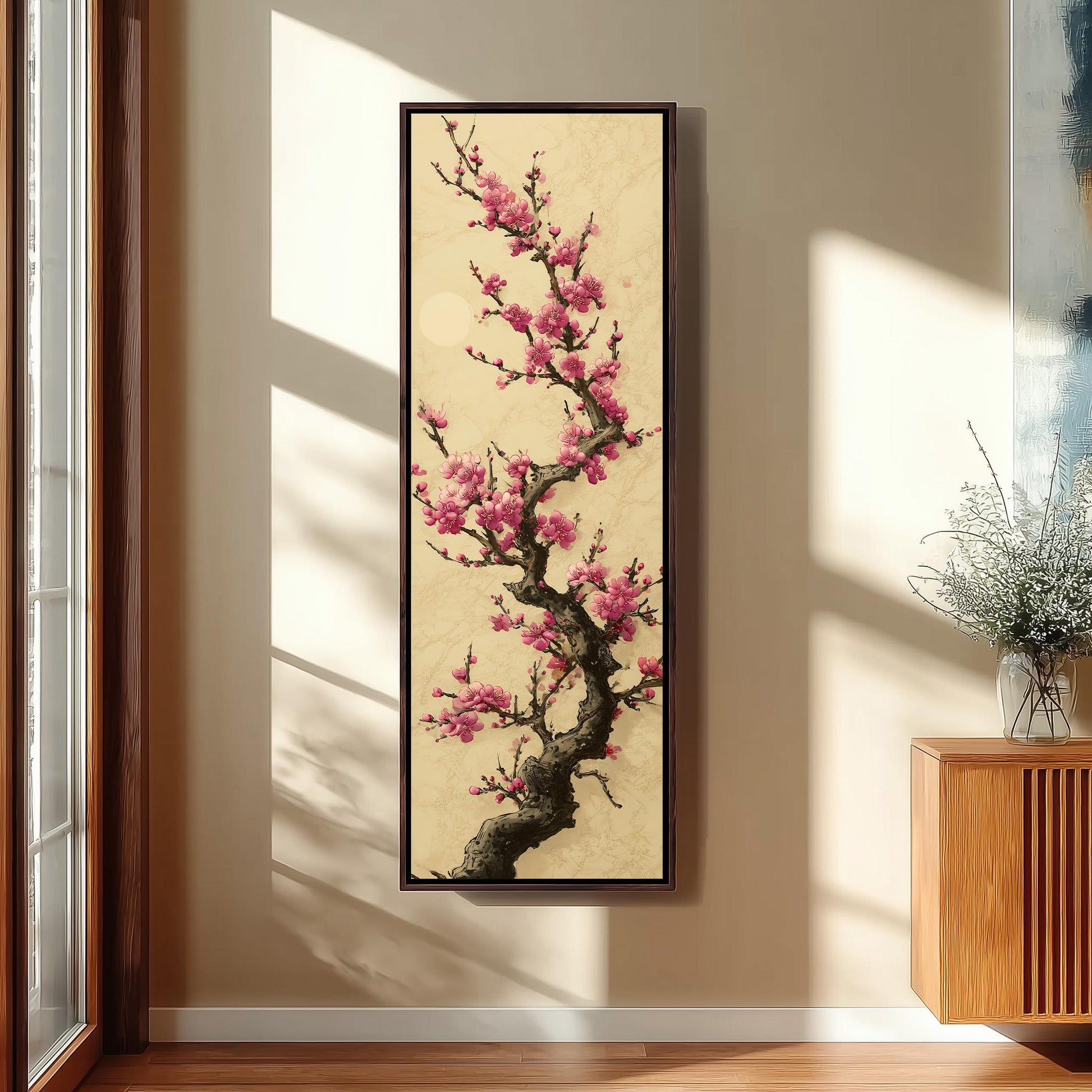 a large framed painting of a cherry blossom tree with pink flowers hanging on a wall.
