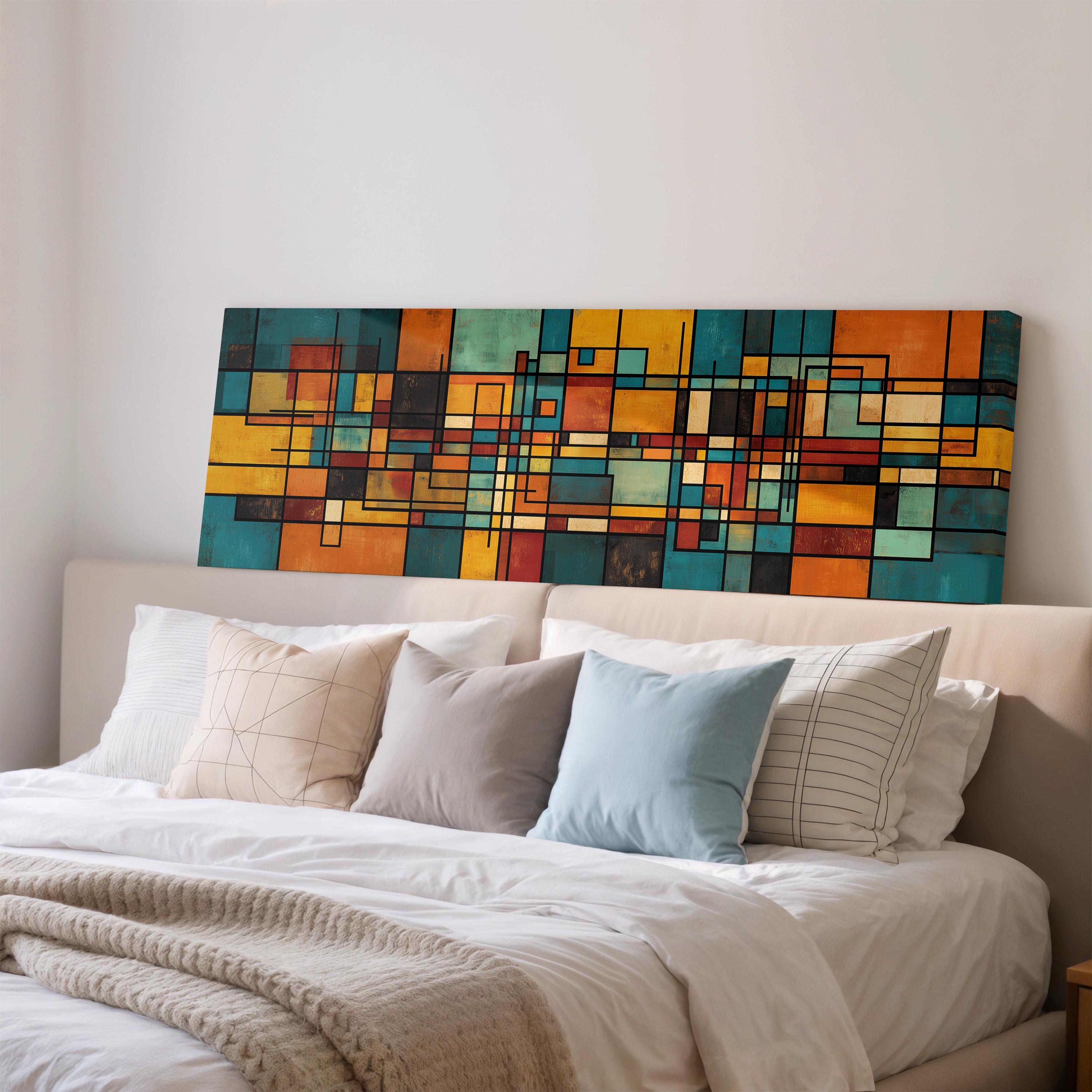 a large abstract painting hanging on a wall above a bed with white pillows and a gray blanket.
