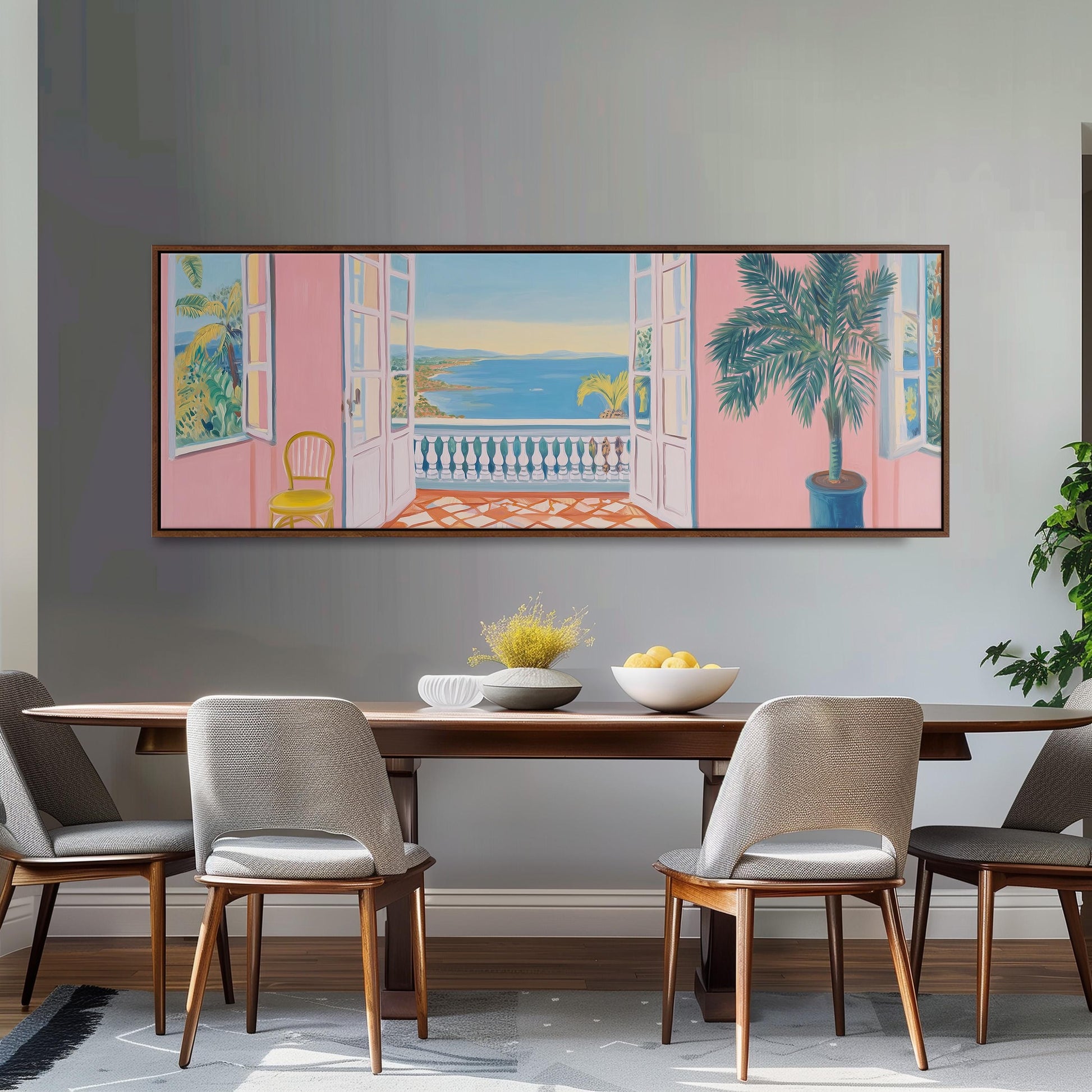 a dining room with a large painting of a balcony and a tropical scene hanging on the wall above a wooden dining table with four chairs.