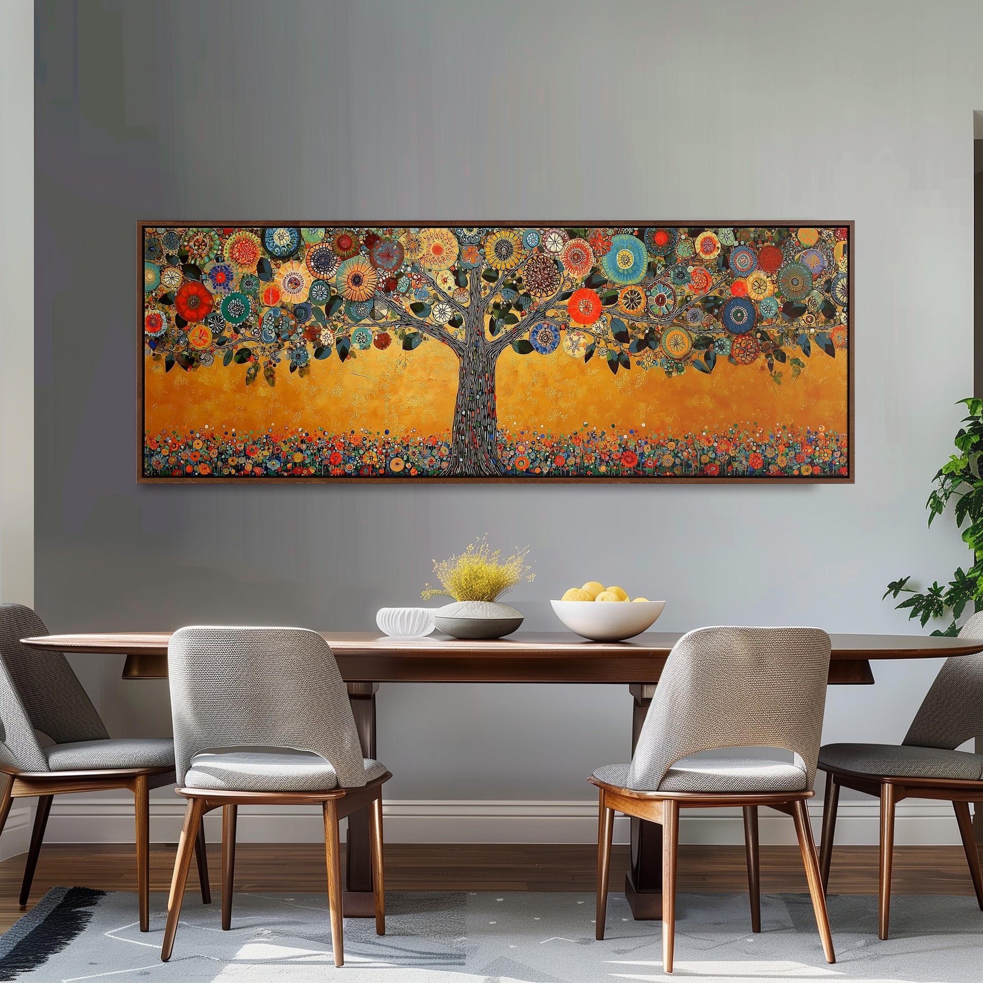 a large, colorful painting of a tree with flowers and leaves hanging on a wall above a wooden dining table with four chairs.