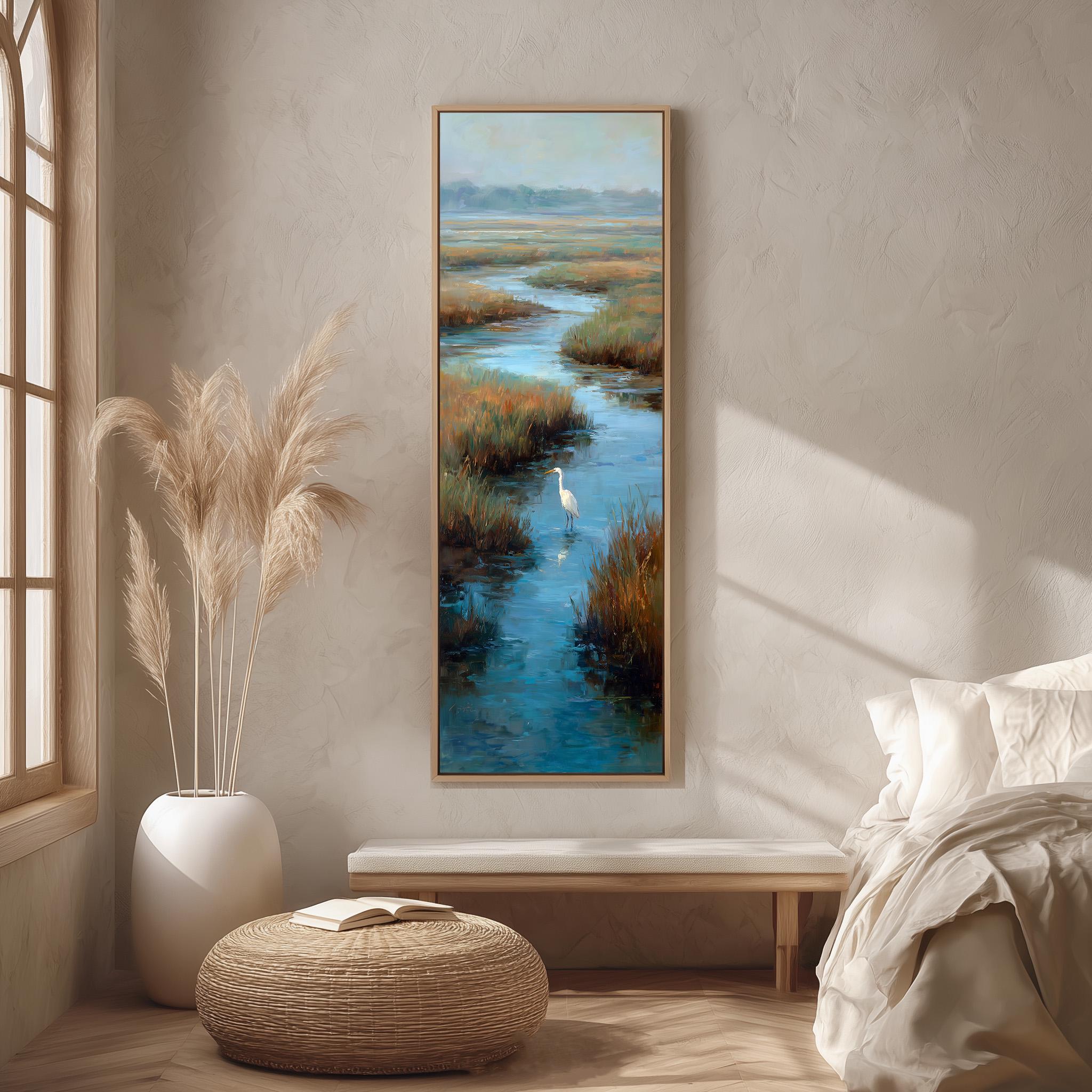a serene bedroom scene with a large painting of a tranquil body of water and a bird in flight hanging on the wall. The painting is framed in a wooden frame and is the focal point of the room. The room is decorated with a white bed, a wicker ottoman, and a potted plant, creating a calm and peaceful atmosphere.