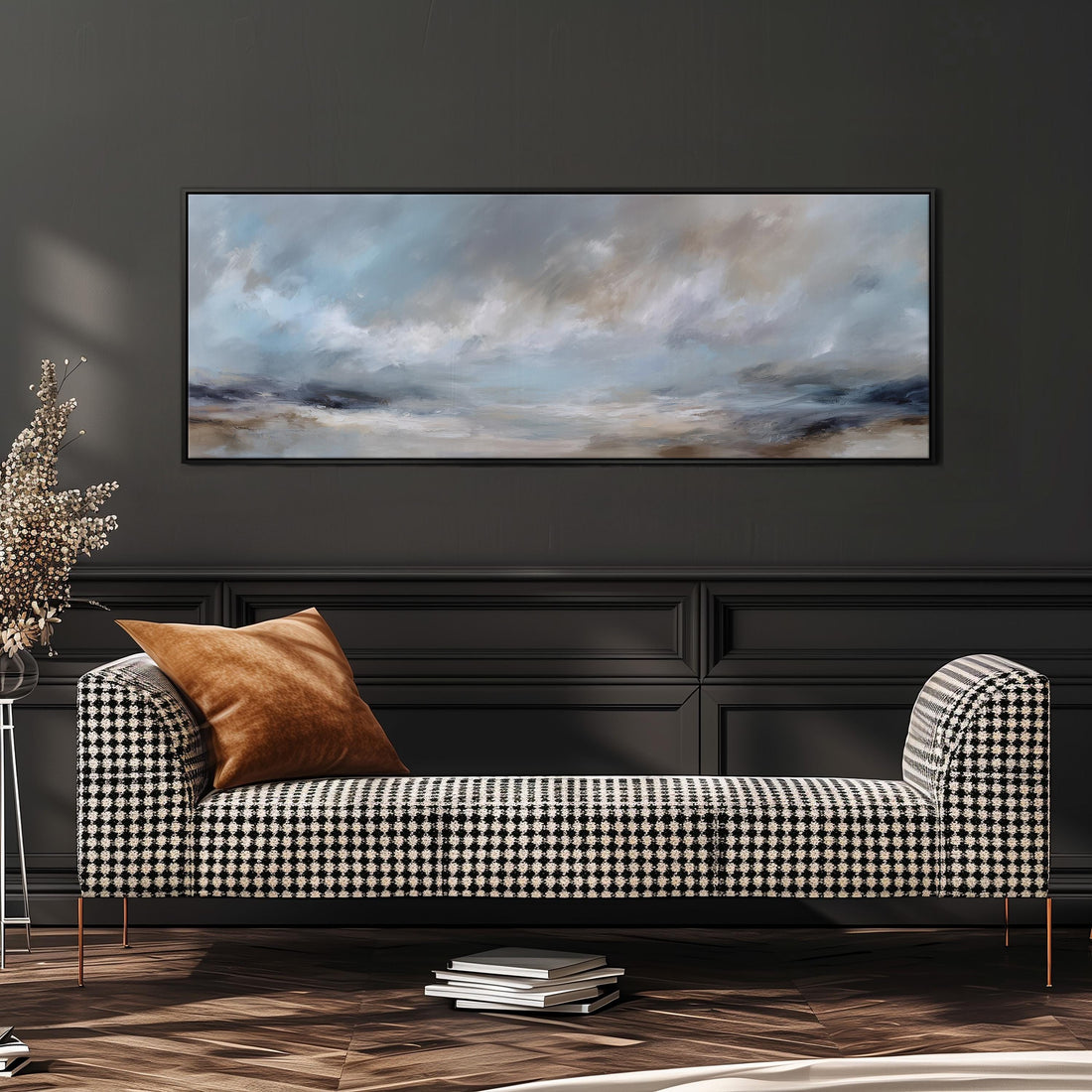 a large, framed painting of a cloudy sky hanging above a white sofa with gray and white plaid throw pillows.