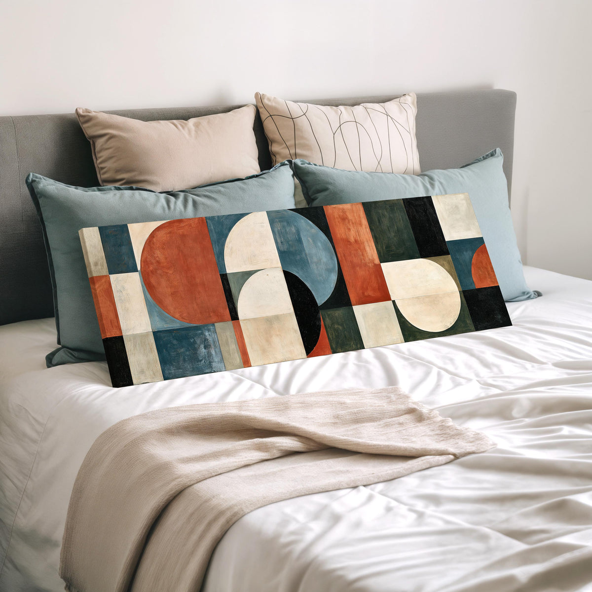 Rust and blue geometric arches and circles wide panoramic canvas print laid on a bed to show its size