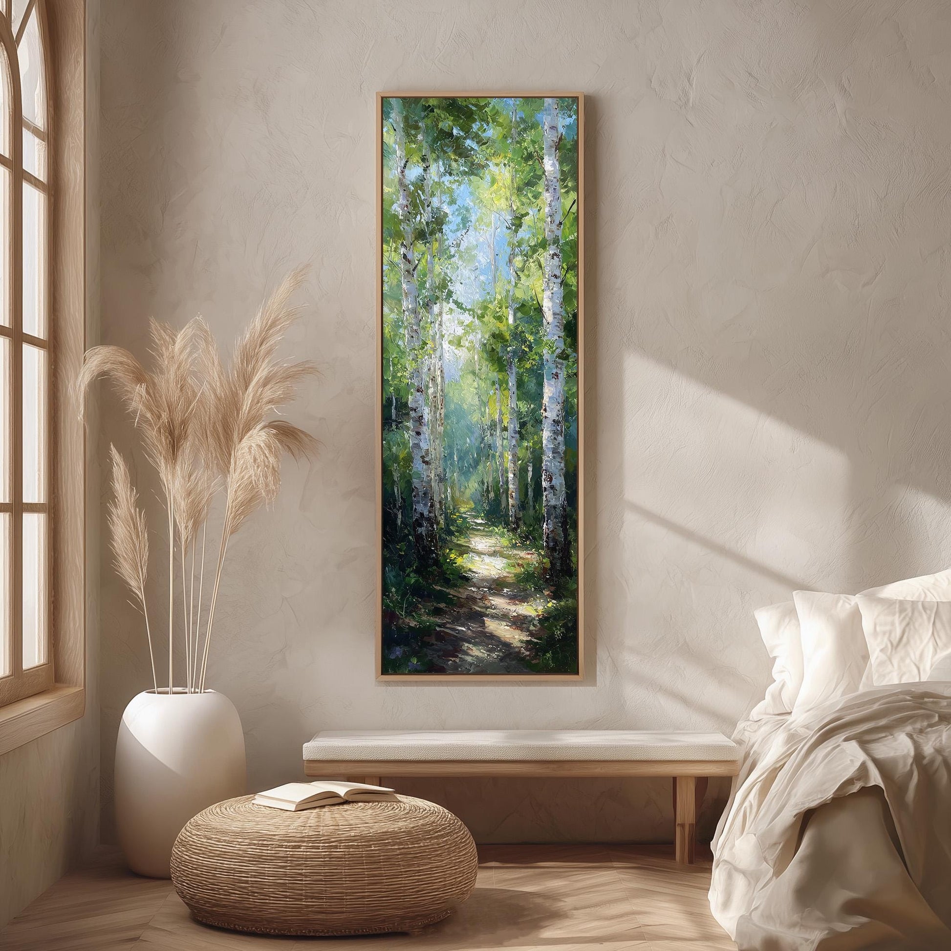 a serene indoor setting with a large painting of a forest scene hanging on the wall. The painting features tall trees with green foliage and a winding path leading through the forest. The room is decorated with a white sofa, a wicker ottoman, and a large window that allows natural light to fill the space.