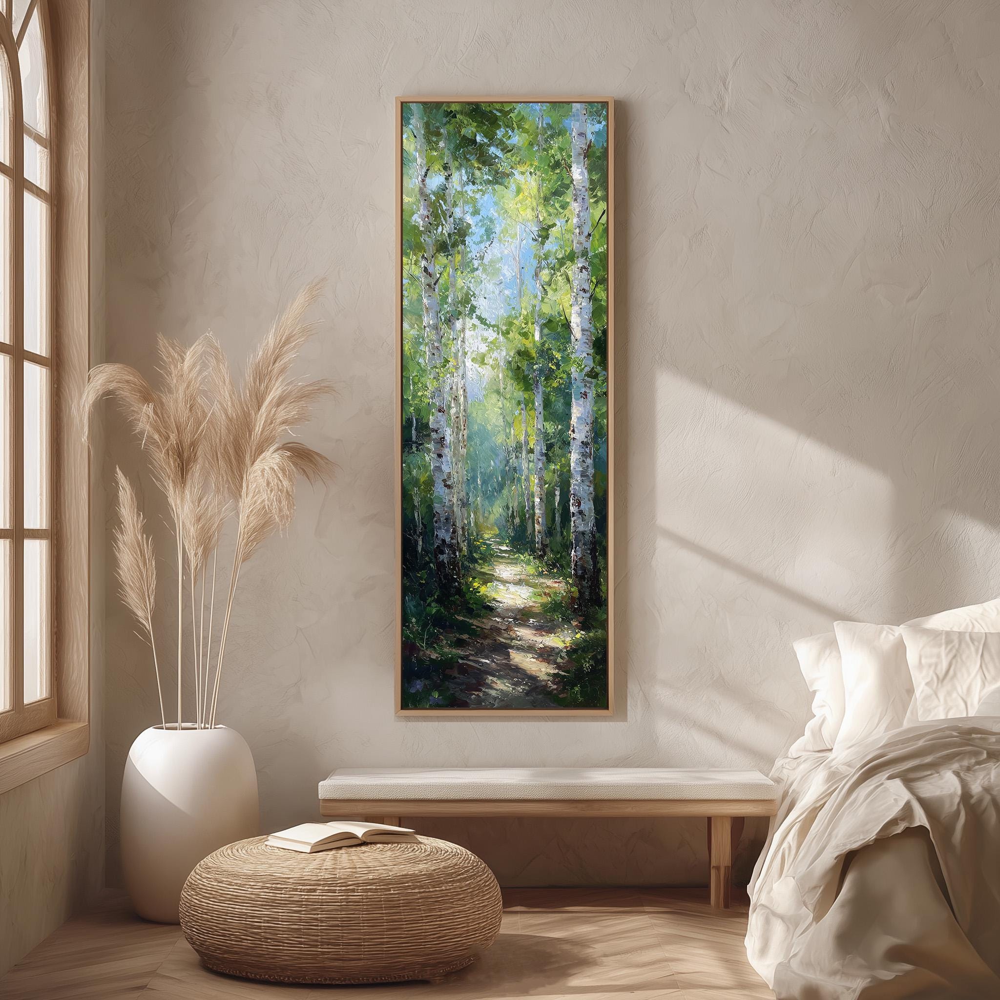 a serene indoor setting with a large painting of a forest scene hanging on the wall. The painting features tall trees with green foliage and a winding path leading through the forest. The room is decorated with a white sofa, a wicker ottoman, and a large window that allows natural light to fill the space.