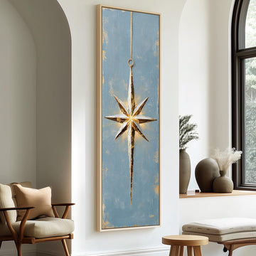 Gold and silver star ornament on blue long vertical canvas print in a sunlit living space