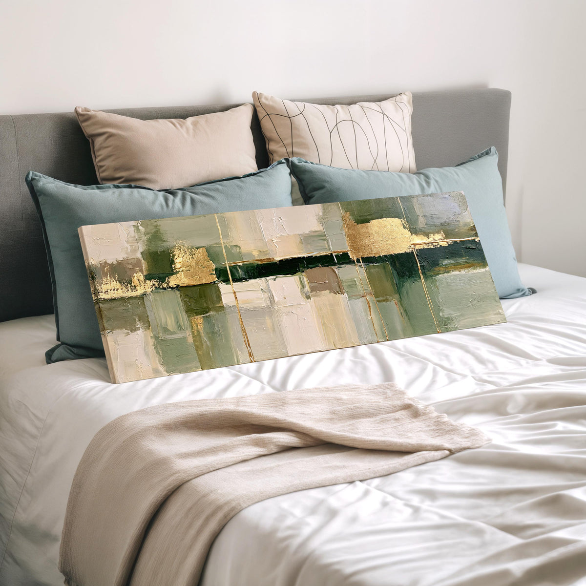 Sage and gold leaf abstract wide panoramic canvas print laid on a bed to show its size