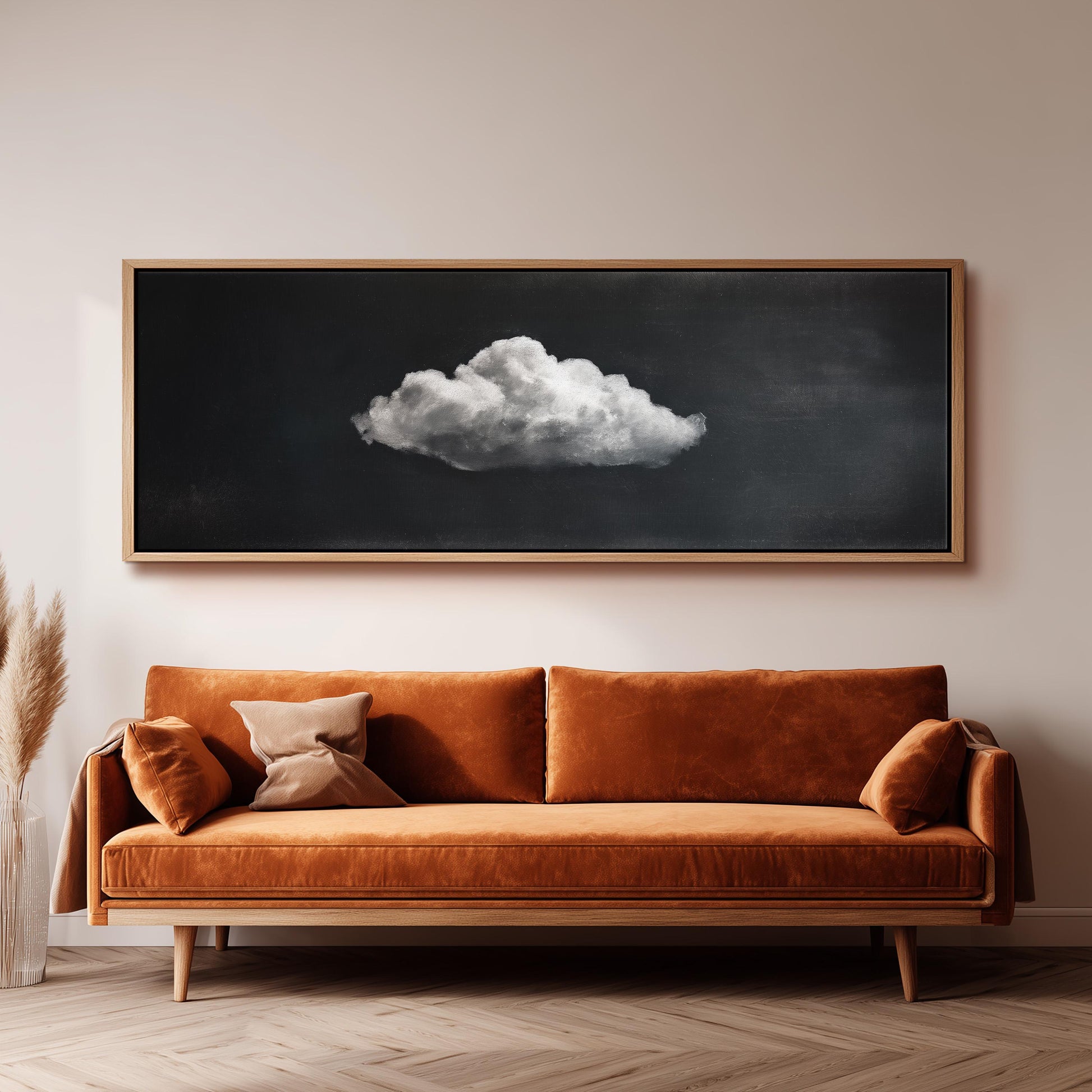 a large, framed painting of a cloud hanging on a wall above a brown sofa.