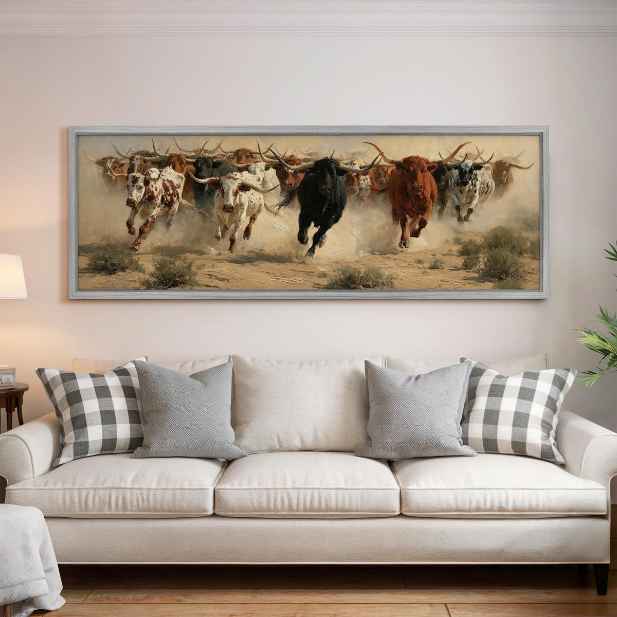 Charging longhorn herd panoramic canvas print above a white sofa in a bright living room