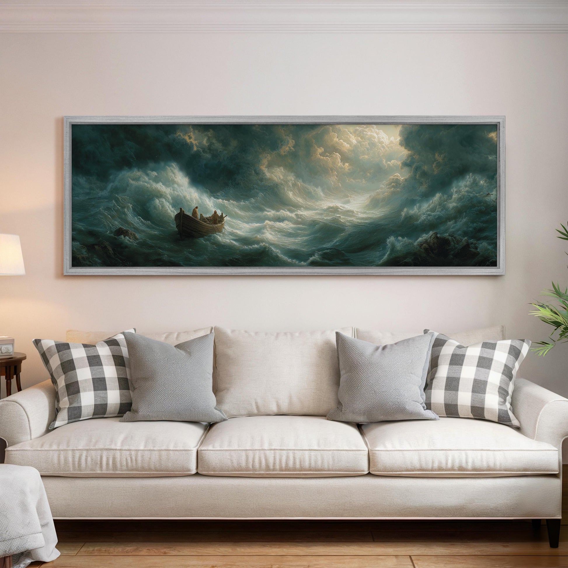 a large painting of a boat sailing through rough seas, hanging on a wall above a white sofa with decorative pillows.