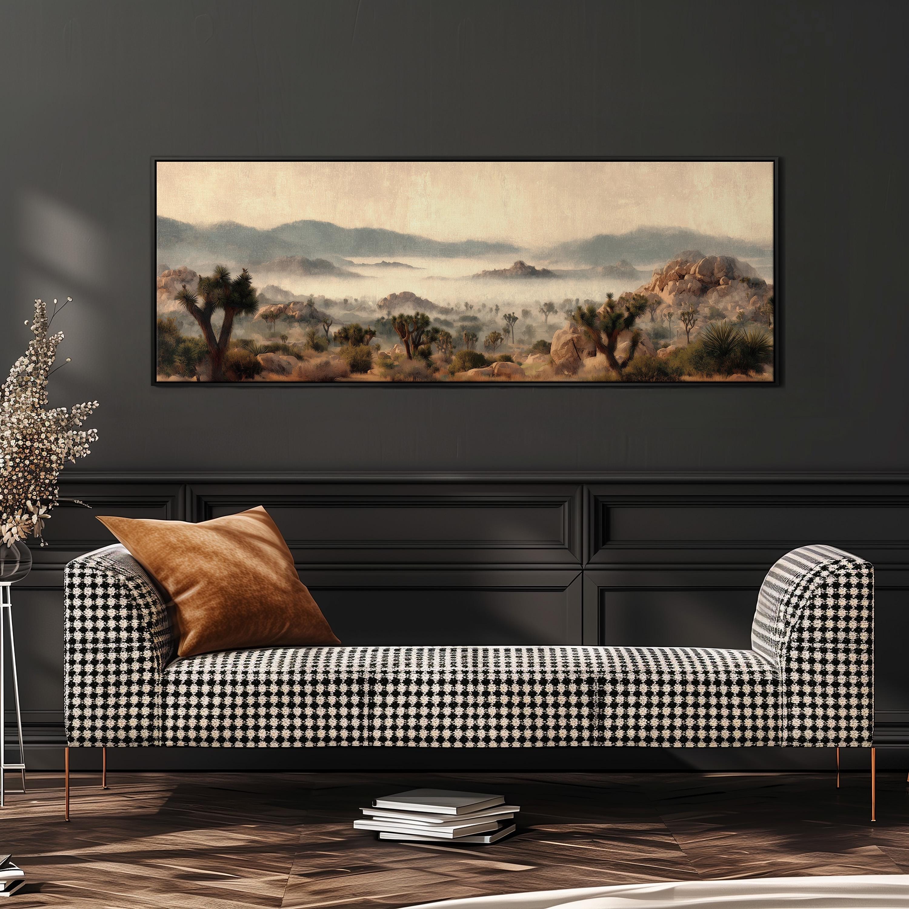 a large painting of a desert landscape hanging on a wall above a black and white checkered sofa with a brown throw pillow.