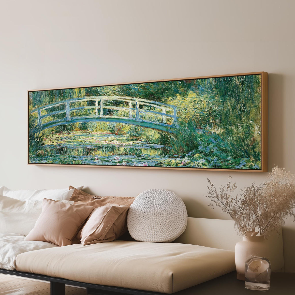 Japanese bridge over a water lily pond panoramic canvas print above a sofa in a living room