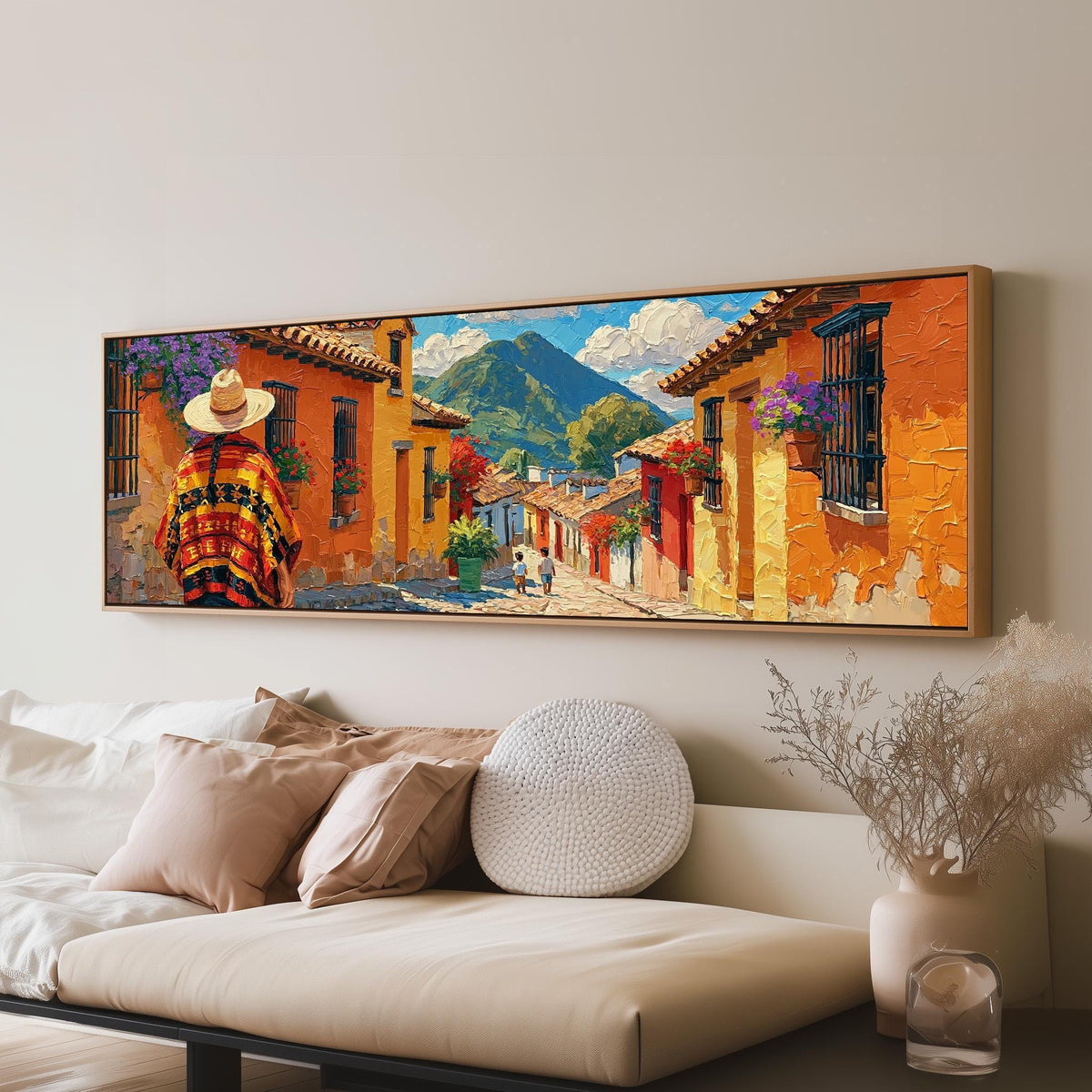 Colorful Guatemalan street with volcano view long horizontal canvas print above a sofa in a living room