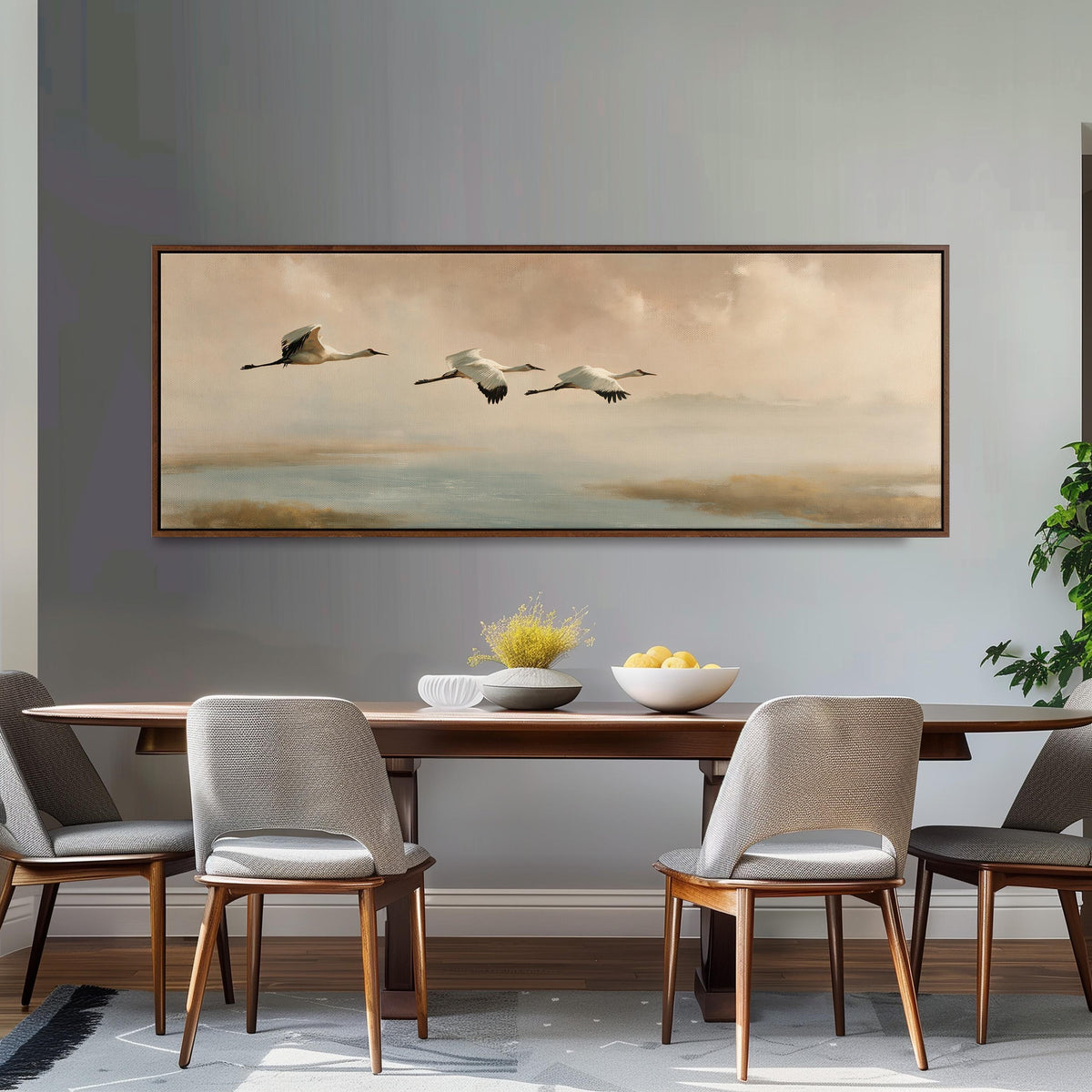 Cranes flying over a calm shore at dusk long horizontal canvas print above a dining table