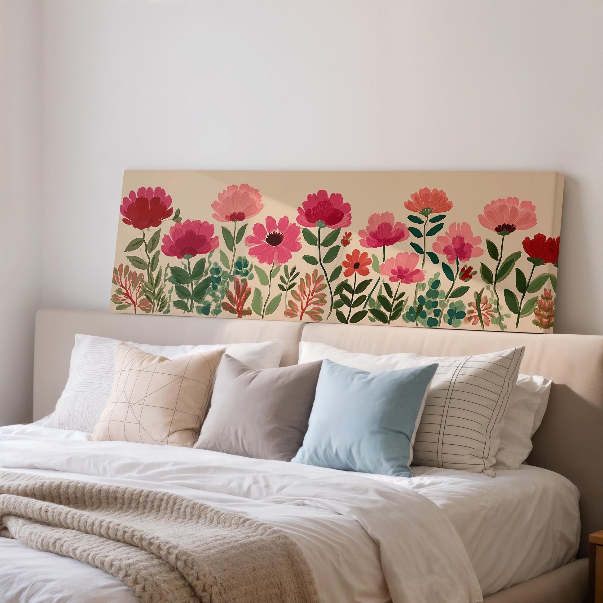 a large floral print on the wall above a bed with white bedding and pillows.