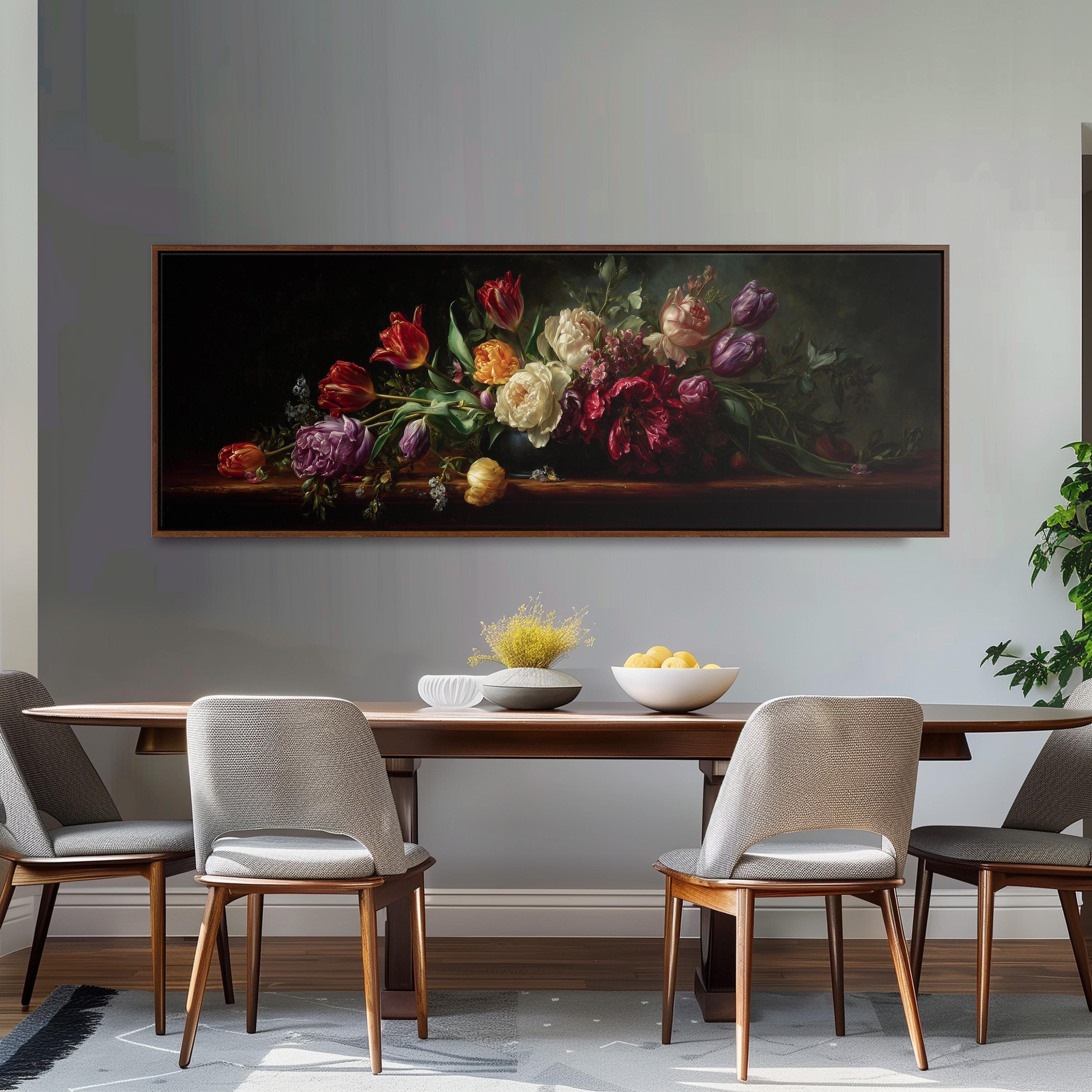 a large painting of a bouquet of flowers hanging on a wall above a wooden dining table with four chairs.