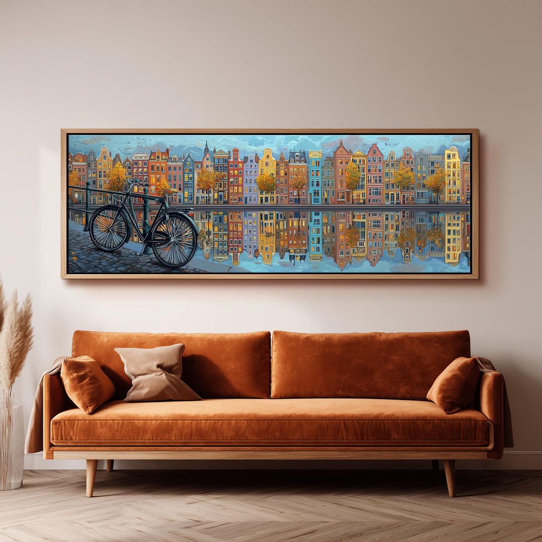 a large painting of a cityscape with a bicycle in the foreground, hanging on a wall above a brown sofa.