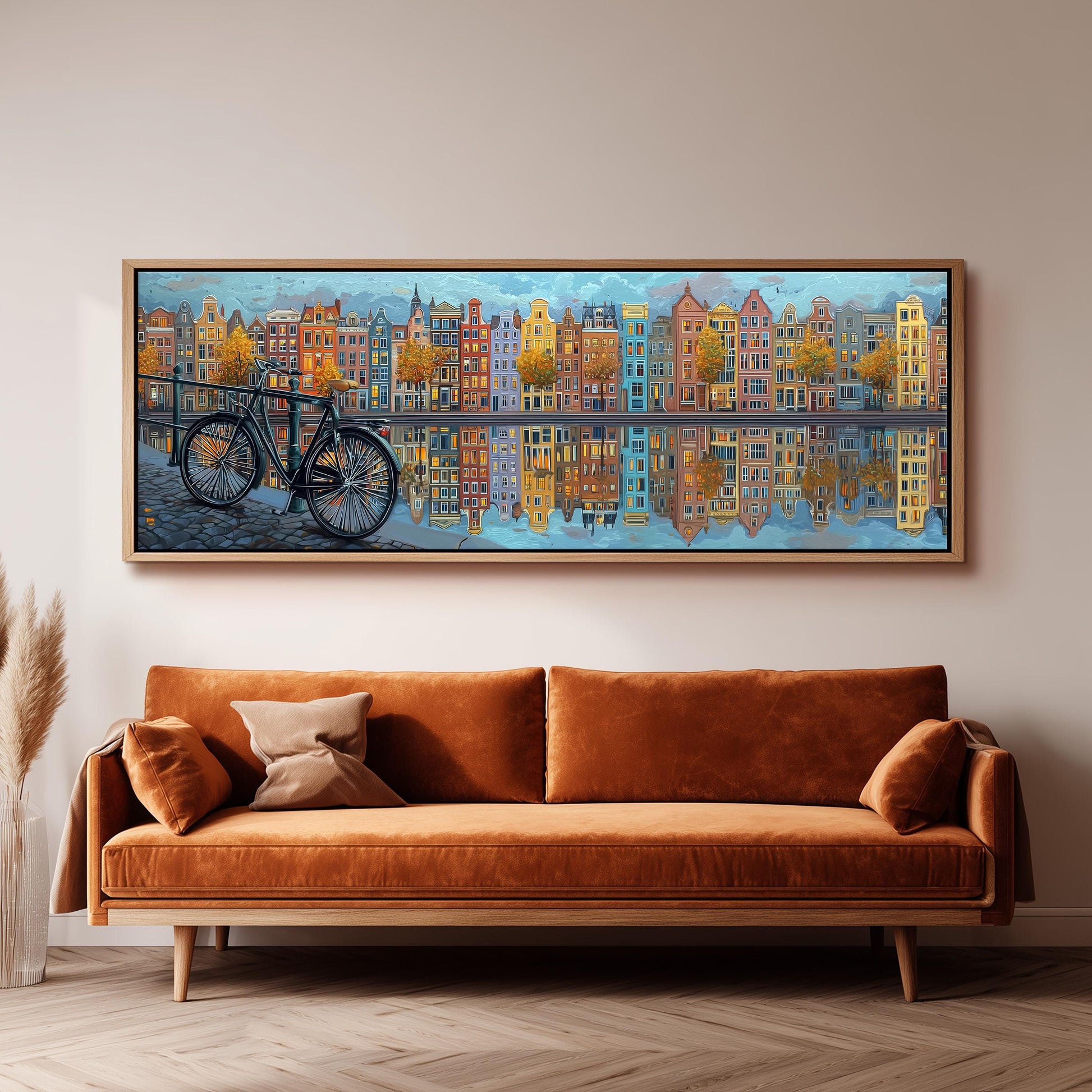a large painting of a cityscape with a bicycle in the foreground, hanging on a wall above a brown sofa.