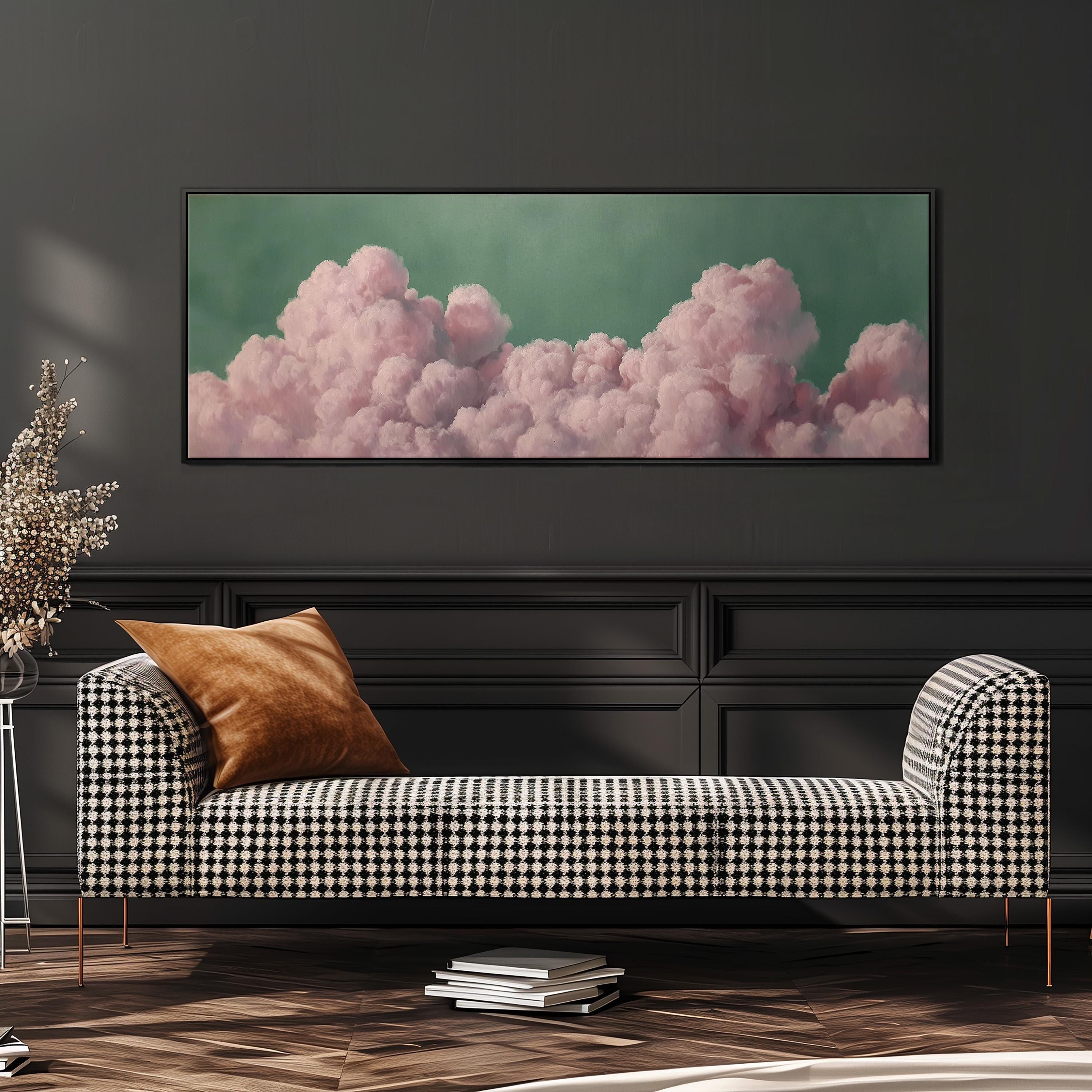 a large, framed picture of pink clouds hanging on a wall above a black and white checkered sofa in a modern living room setting.