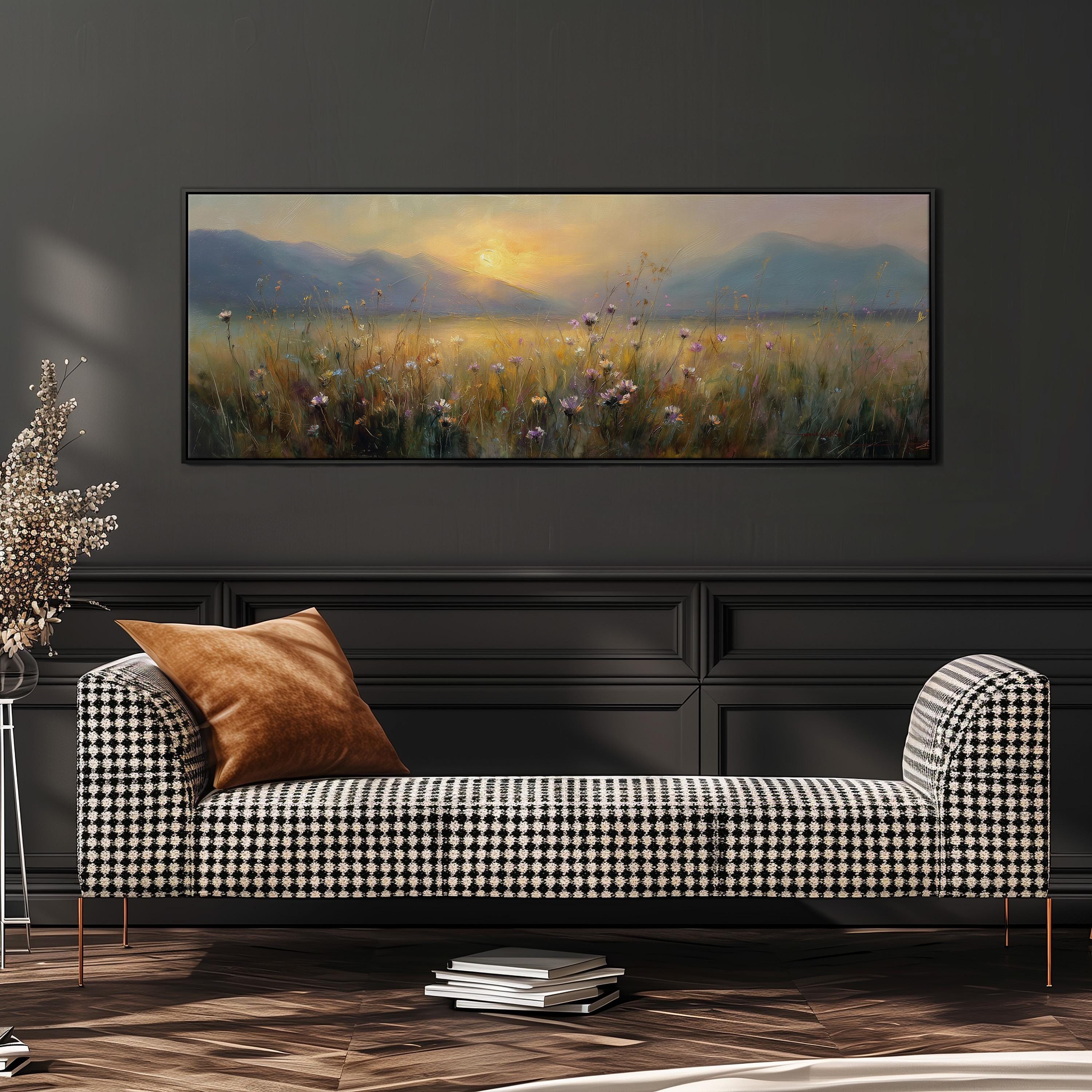 a large painting of a field with flowers hanging on a wall above a black and white checkered sofa.