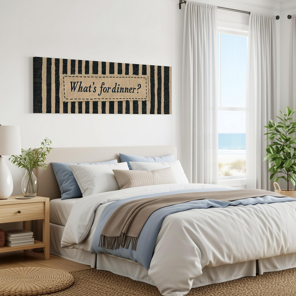 What's for dinner sign on black stripes panoramic canvas print above a bed in a coastal bedroom