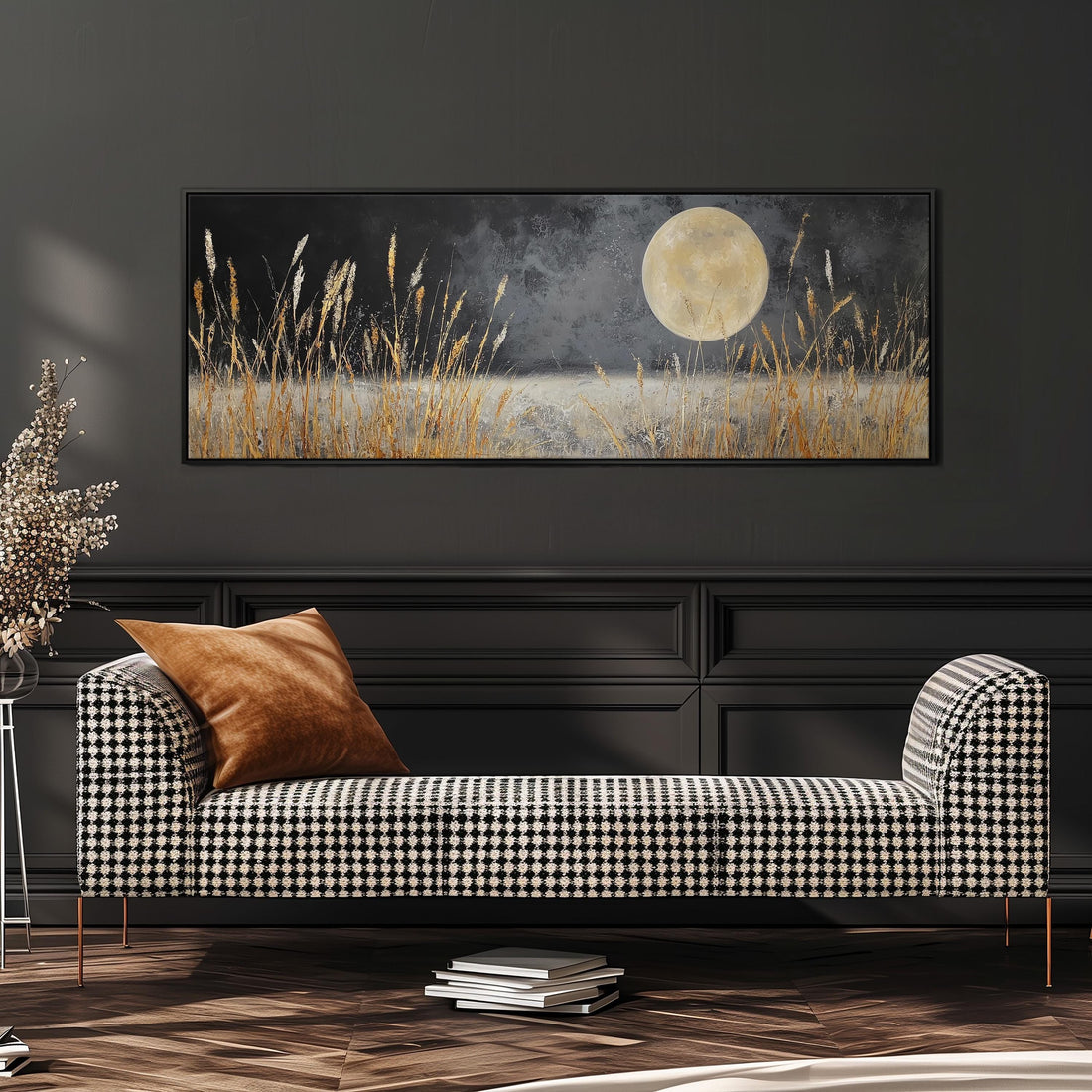 a large black and white checkered sofa with a brown throw pillow, set against a dark wall with a framed painting of a field with tall grass and a full moon in the background.
