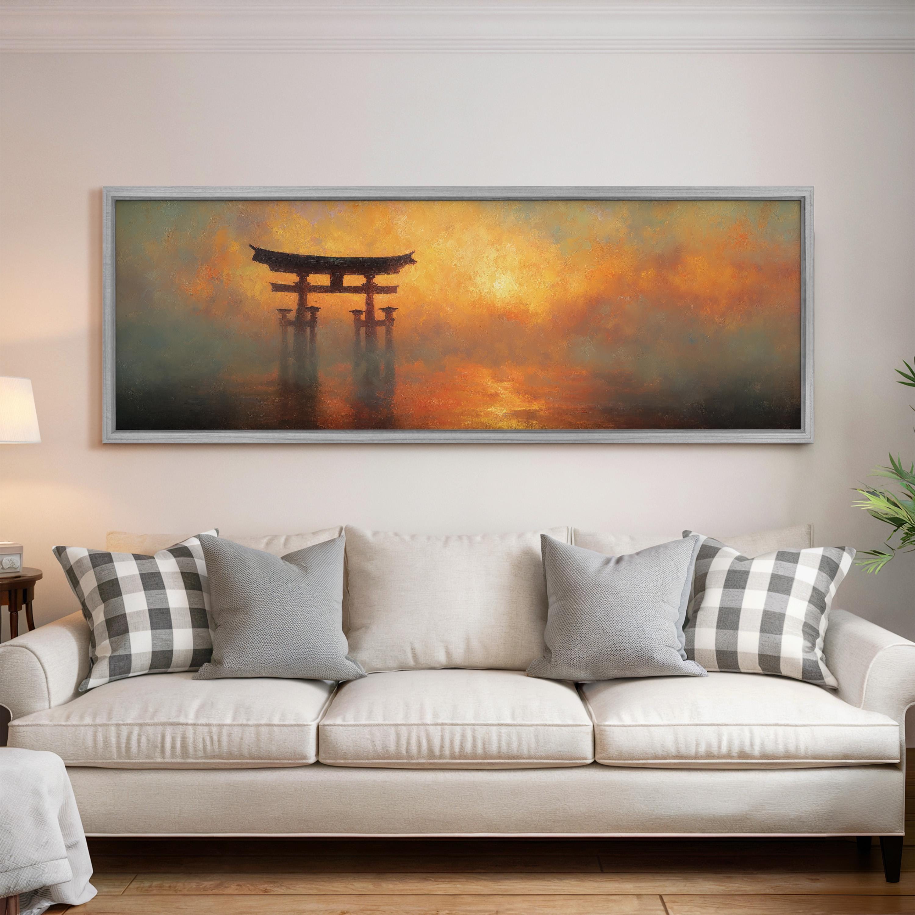 a large painting of a torii gate in a misty landscape, hanging on a wall above a white sofa with patterned throw pillows.