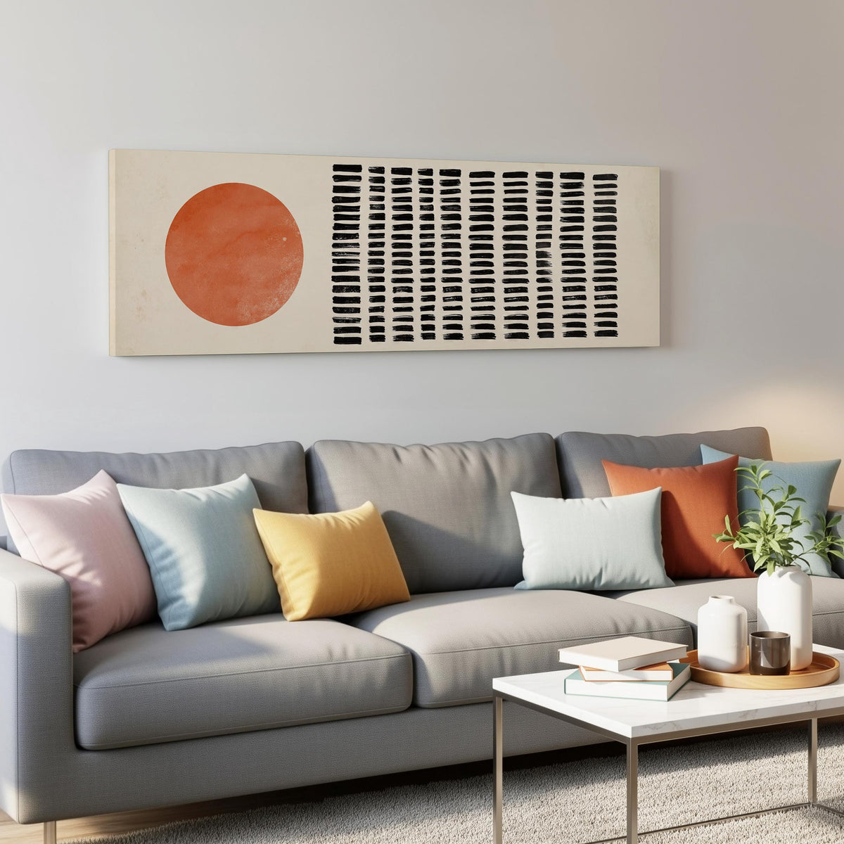 Orange sun beside rows of black dashes panoramic canvas print above a grey sofa in a living room
