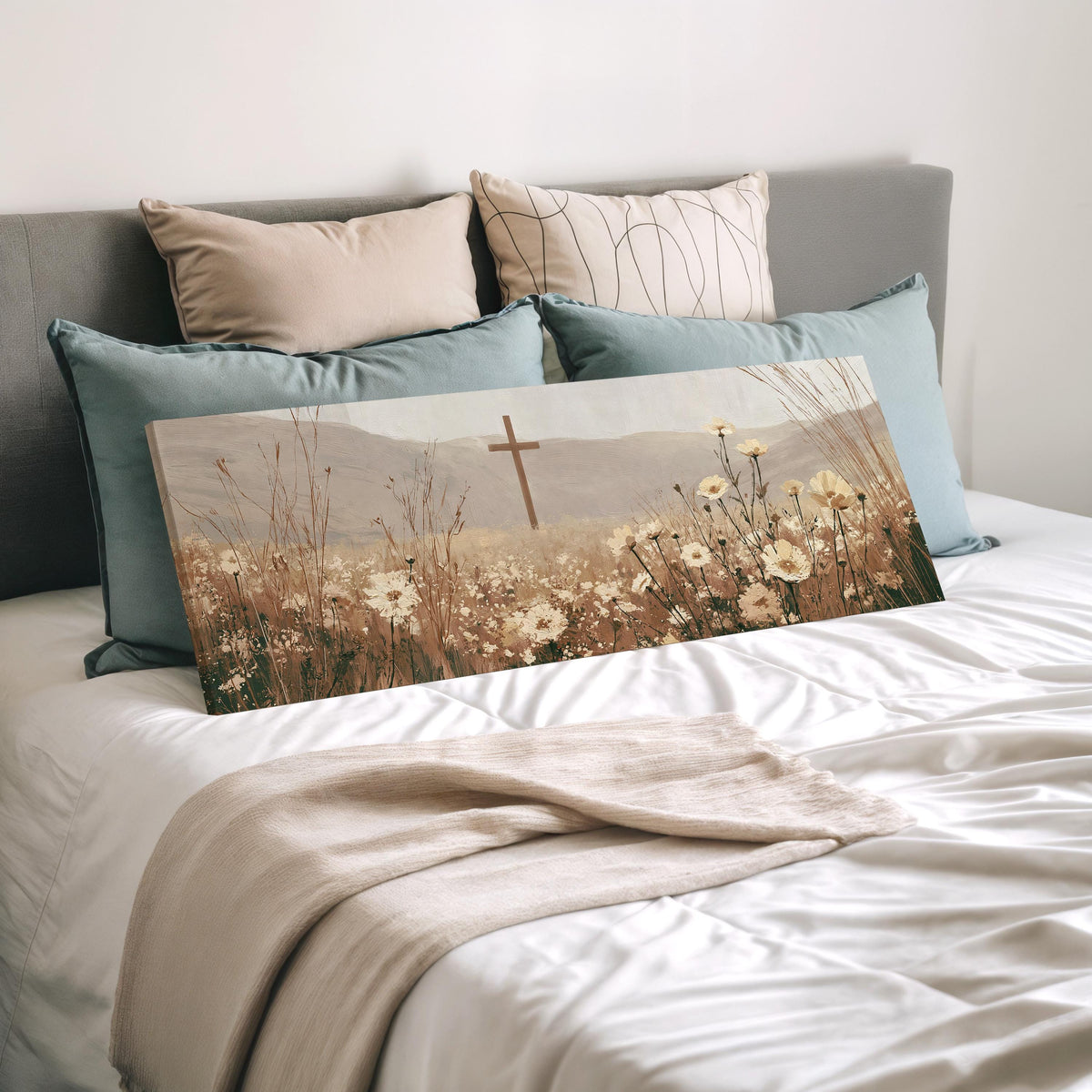 Wooden cross in a cream wildflower field wide panoramic canvas print laid on a bed to show its size