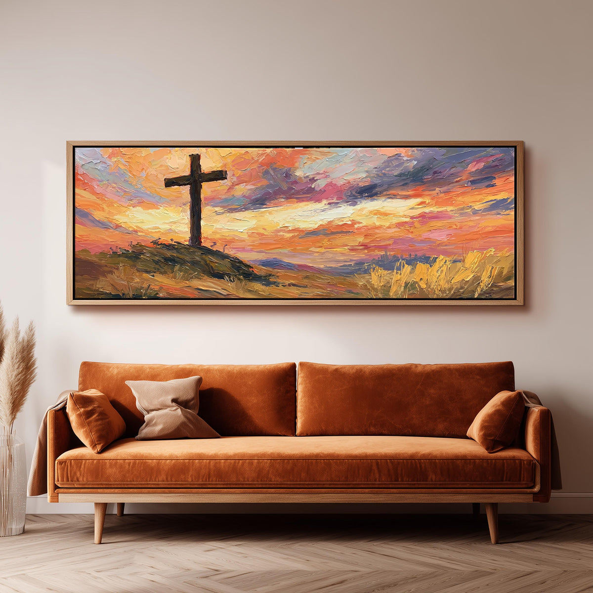 Cross on a hill at sunset panoramic canvas print above a sofa in a living room