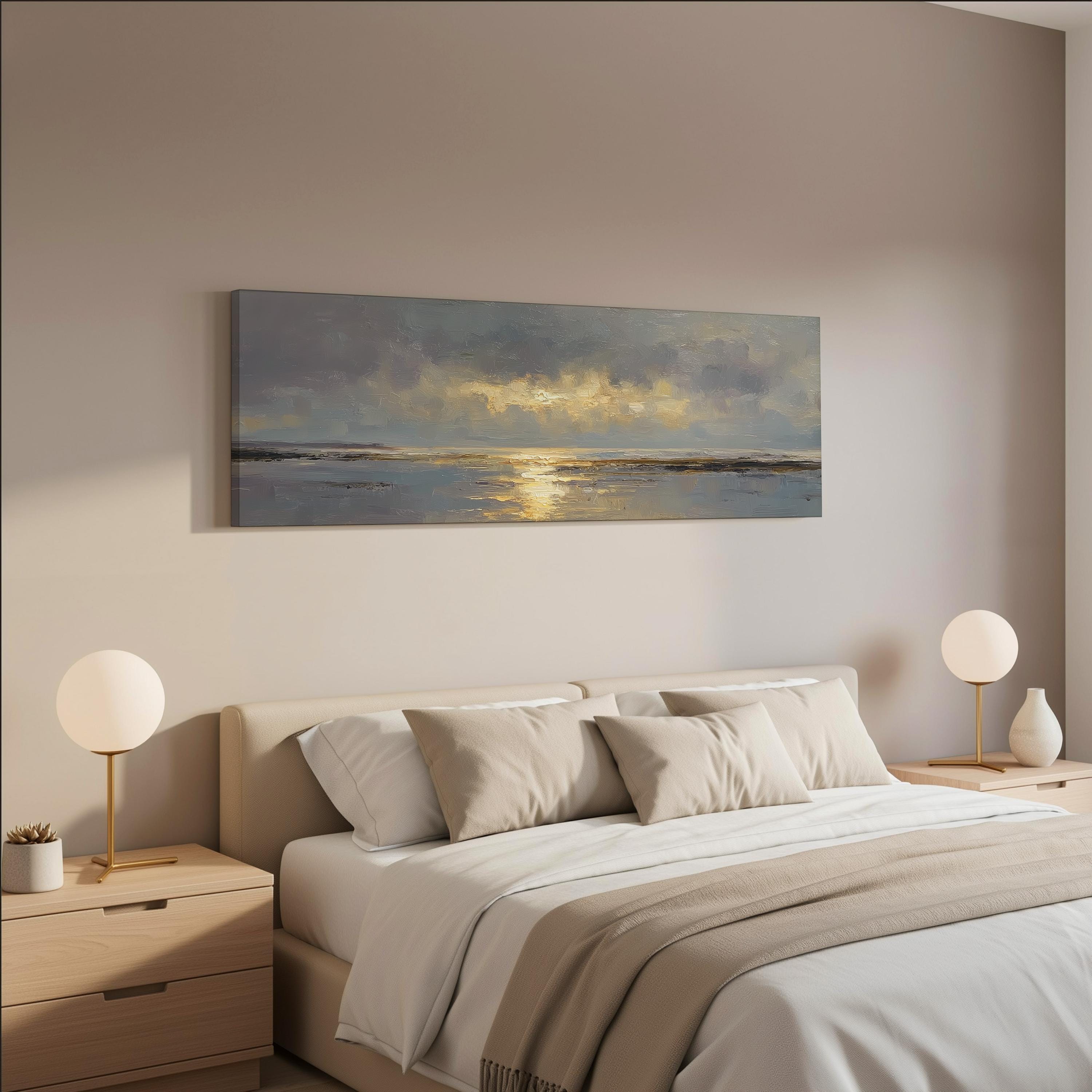 a serene bedroom scene with a large bed, two nightstands with lamps, and a painting of a sunset over the ocean hanging on the wall above the bed.