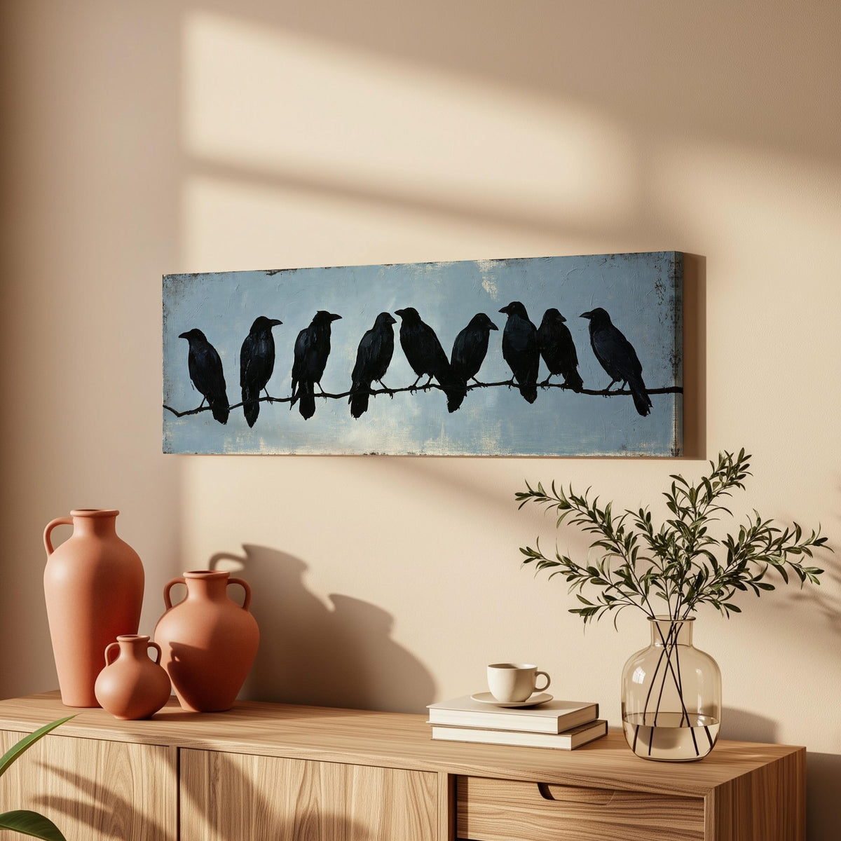 Crows gathered on a branch long horizontal canvas print above a wooden sideboard