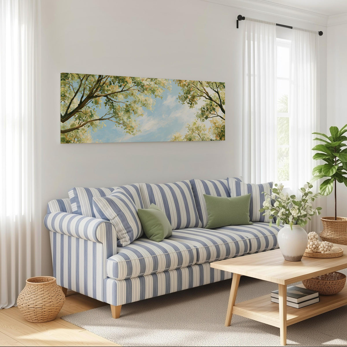 Sunlit leafy branches framing soft clouds long horizontal canvas print above a striped sofa in a coastal living room