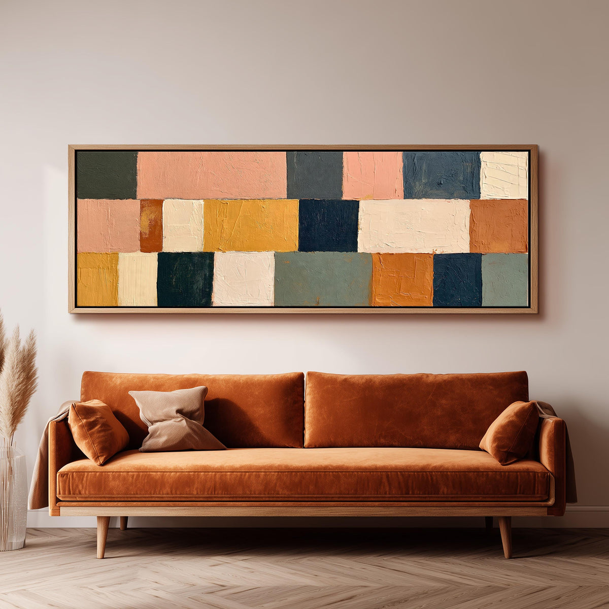Mustard, sage, blush and navy patchwork panoramic canvas print above a sofa in a living room
