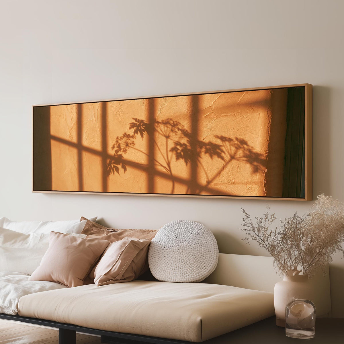 Plant and window shadows on a terracotta wall panoramic canvas print above a sofa in a living room