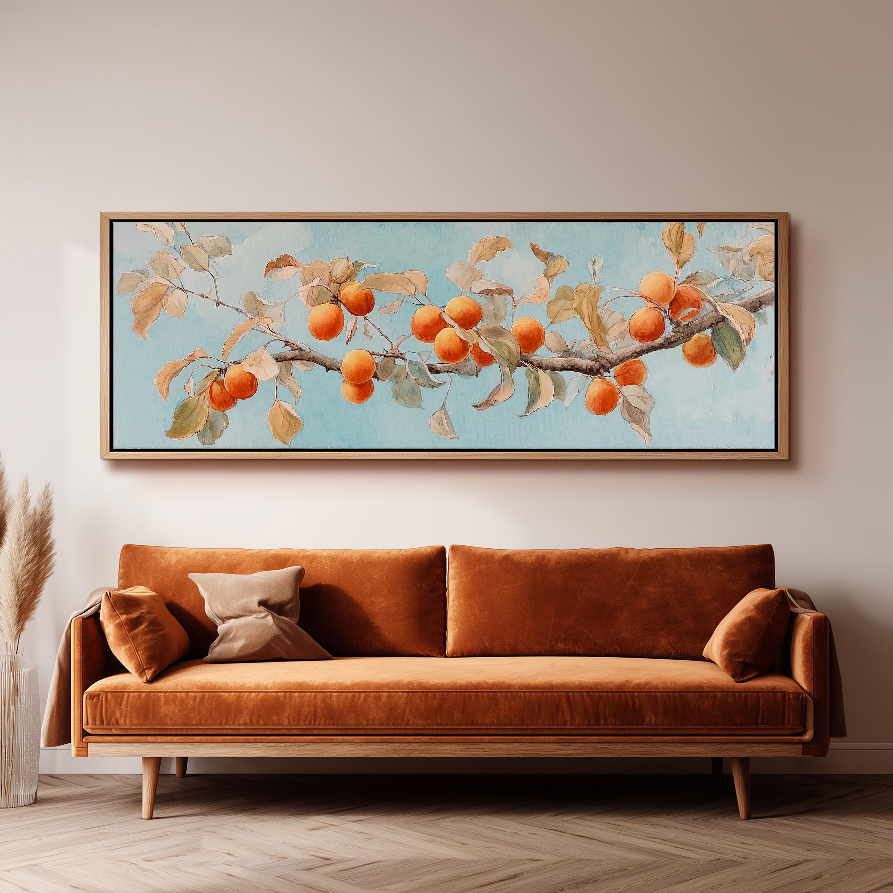 a large painting of a branch with oranges hanging from it, hanging on a wall above a brown sofa.