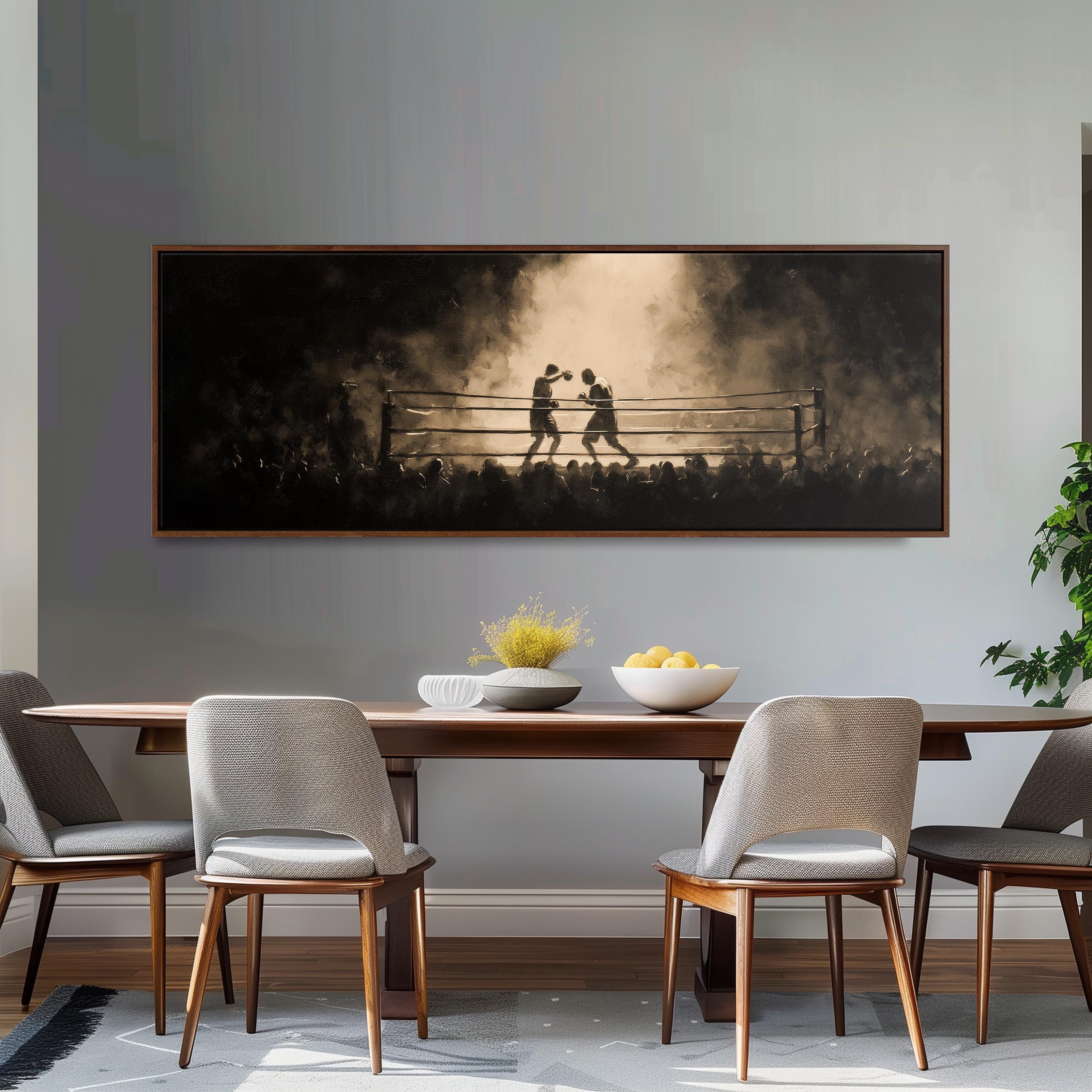 a dining room with a large framed black and white photograph of two people boxing on the wall above a wooden dining table with four chairs.