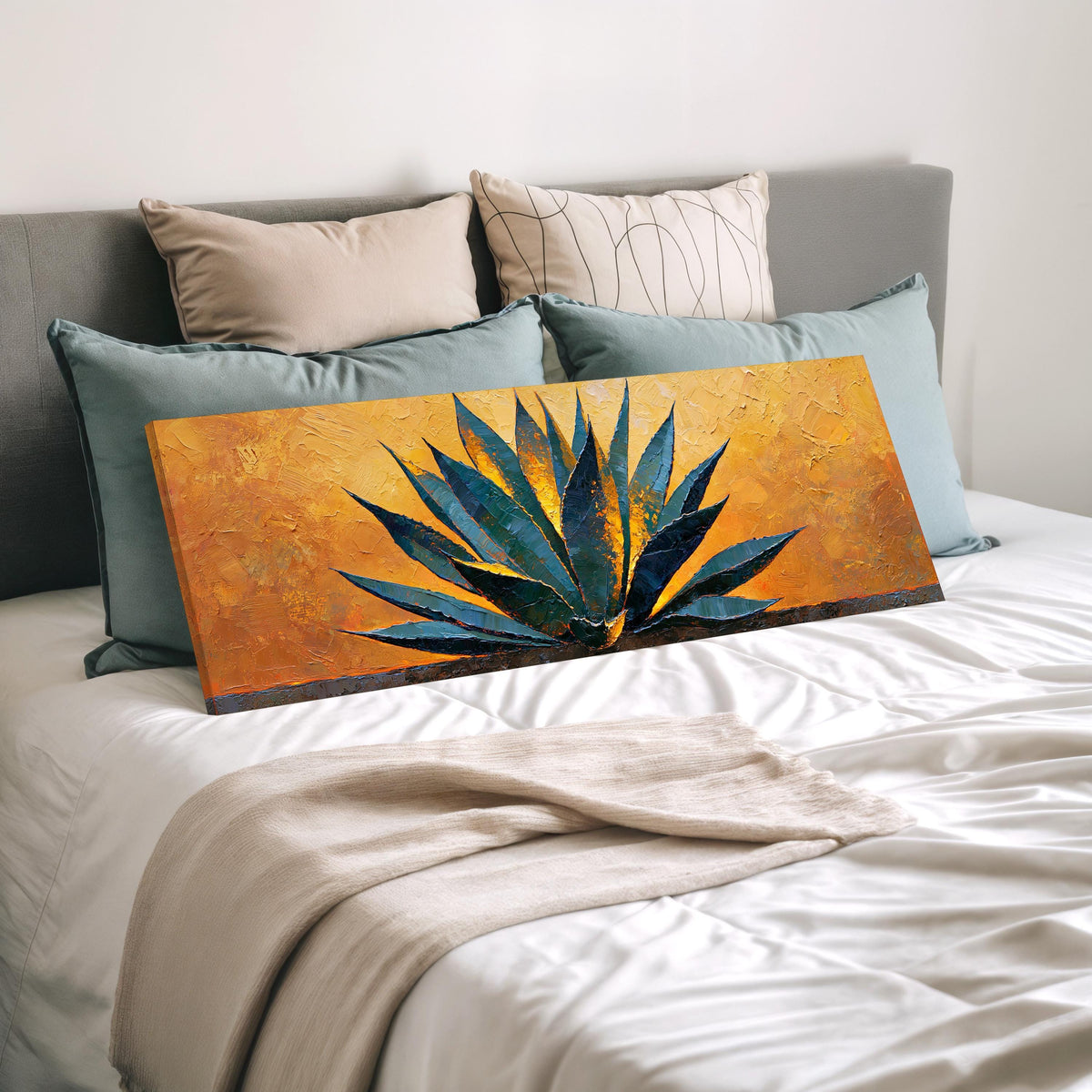 Blue agave on a textured gold background wide panoramic canvas print laid on a bed to show its size