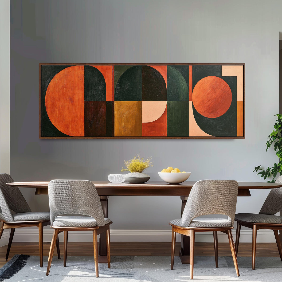Orange circles and arches on forest green long horizontal canvas print above a dining table