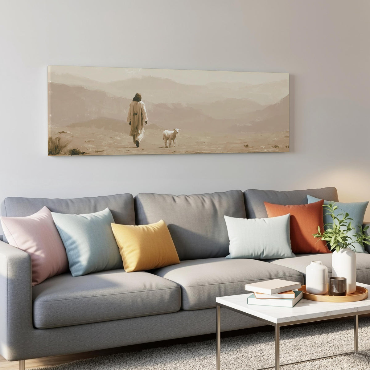Jesus walking with a lamb through the desert panoramic canvas print above a grey sofa in a living room