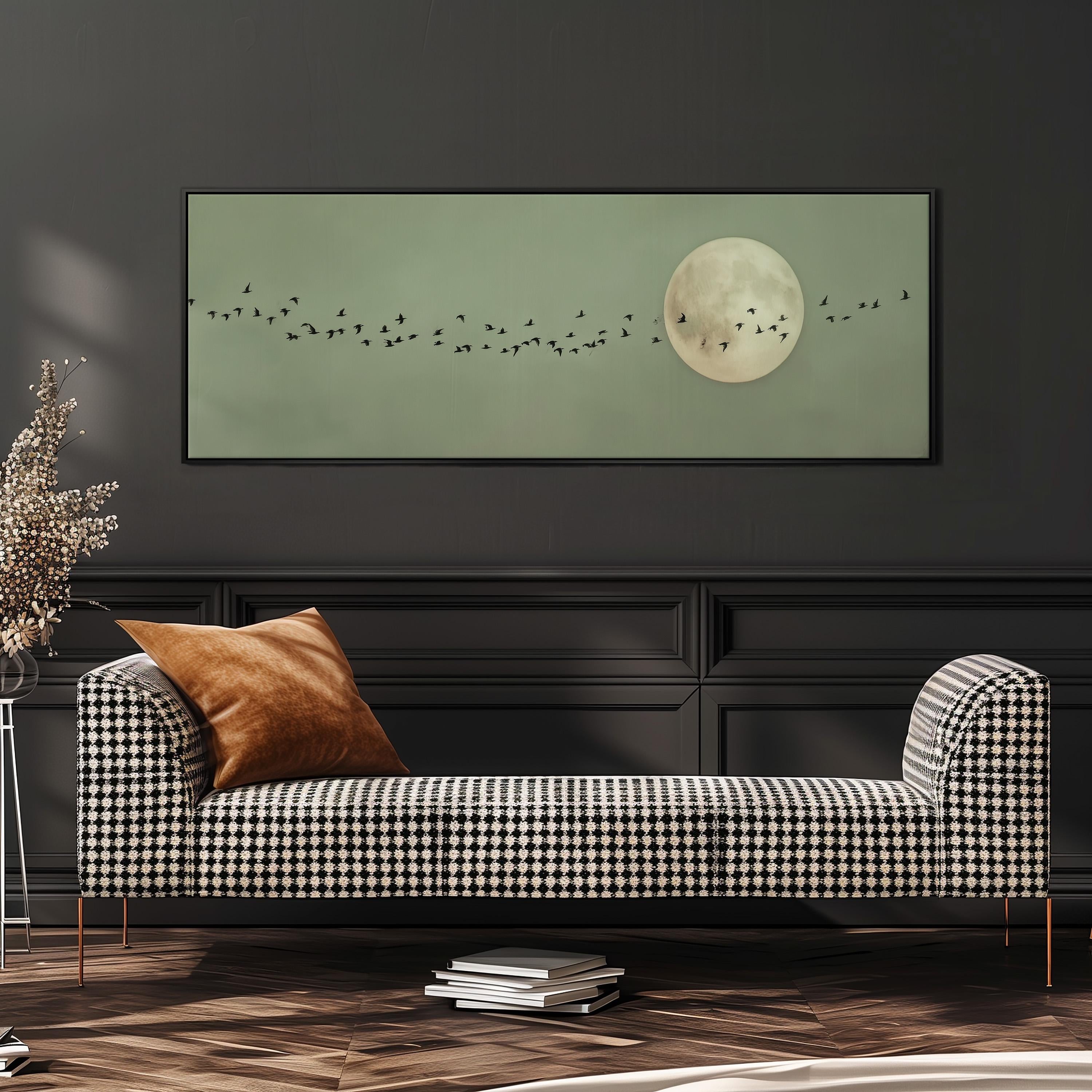 a large, framed artwork depicting a flock of birds flying across a moonlit sky, with a black and white checkered pattern on the sofa in the foreground.